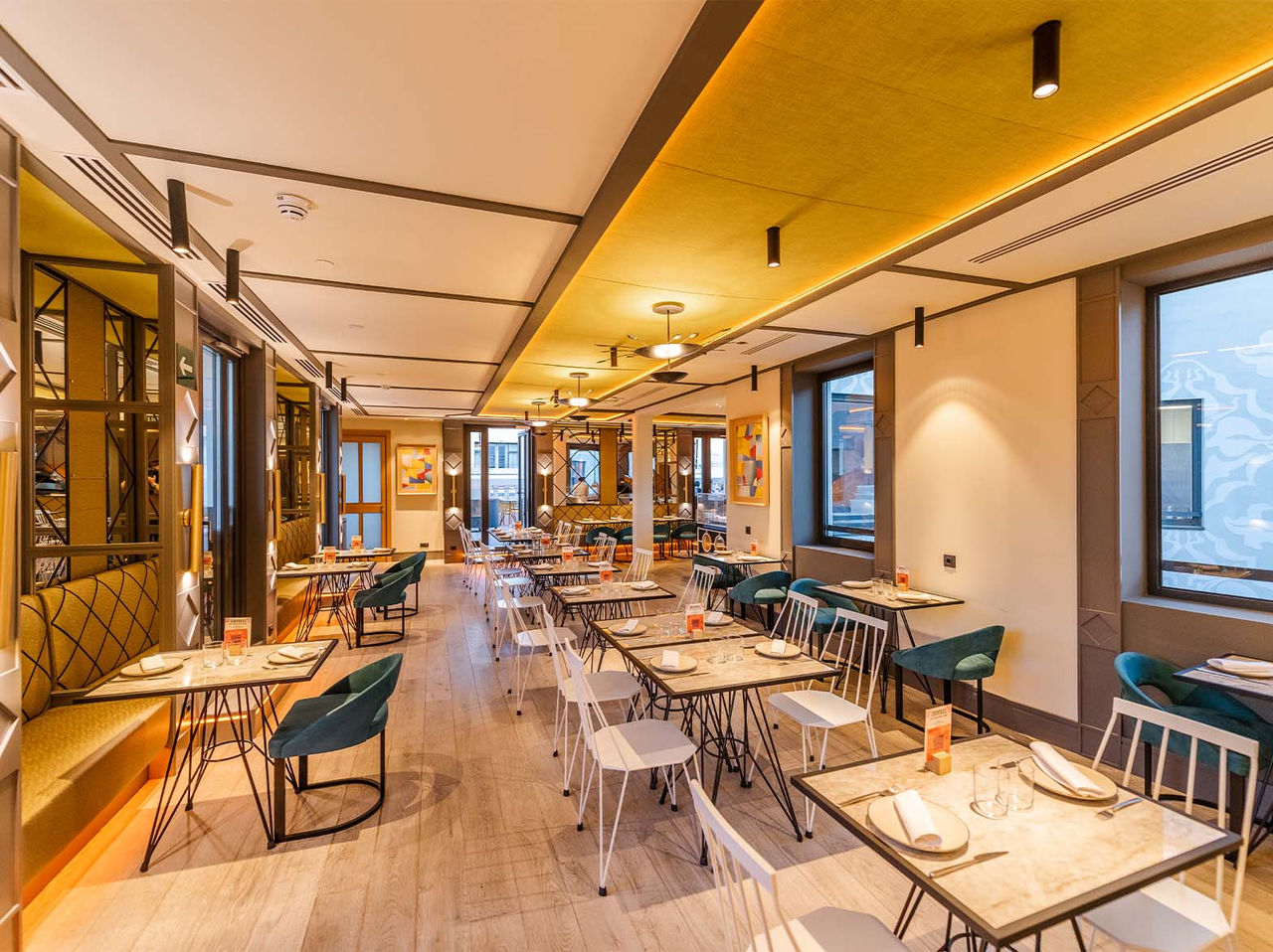 El restaurante Pizzaria, del Hotel en el Centro de Madrid, España, tiene un espacio interior con mesas y sofás modernos