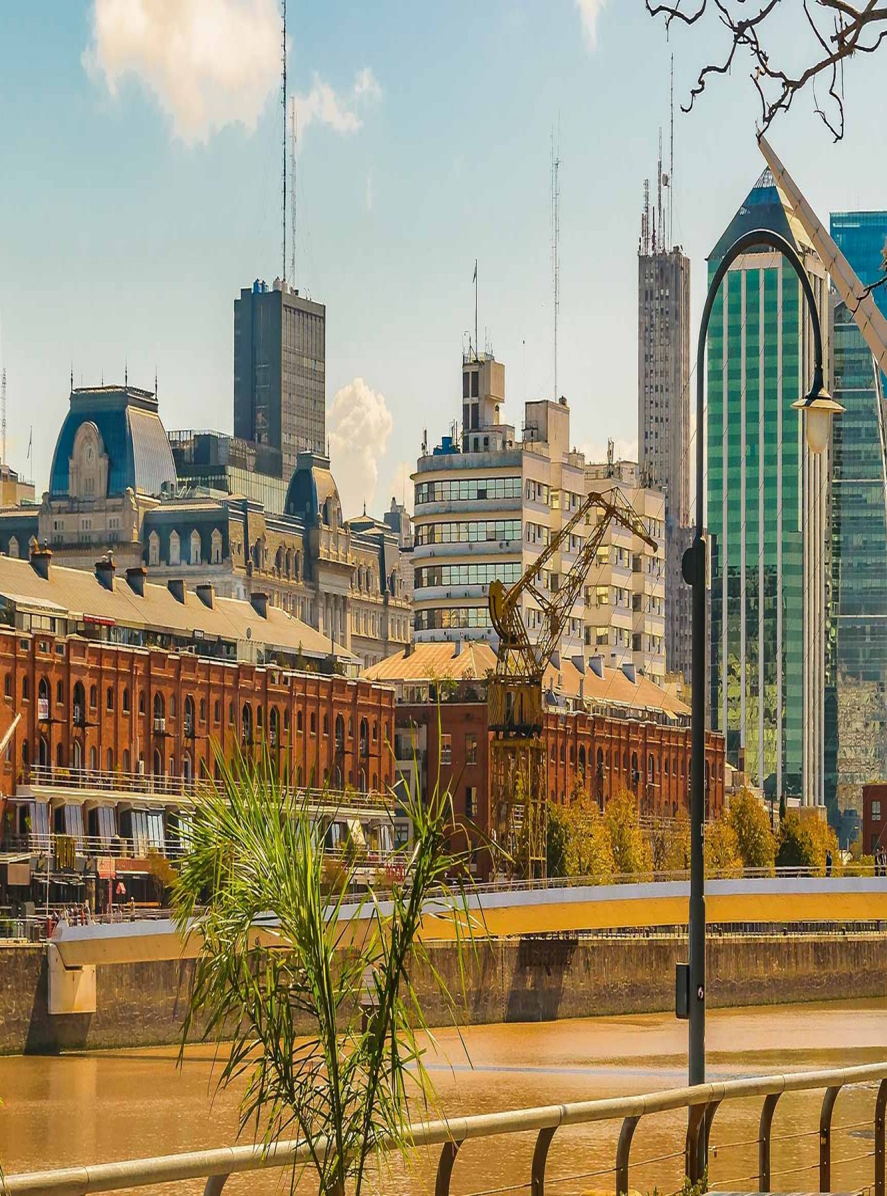 Paisagem urbana de Buenos Aires com o bairro portuário de Puerto Madero, com edifícios altos e um rio Prata