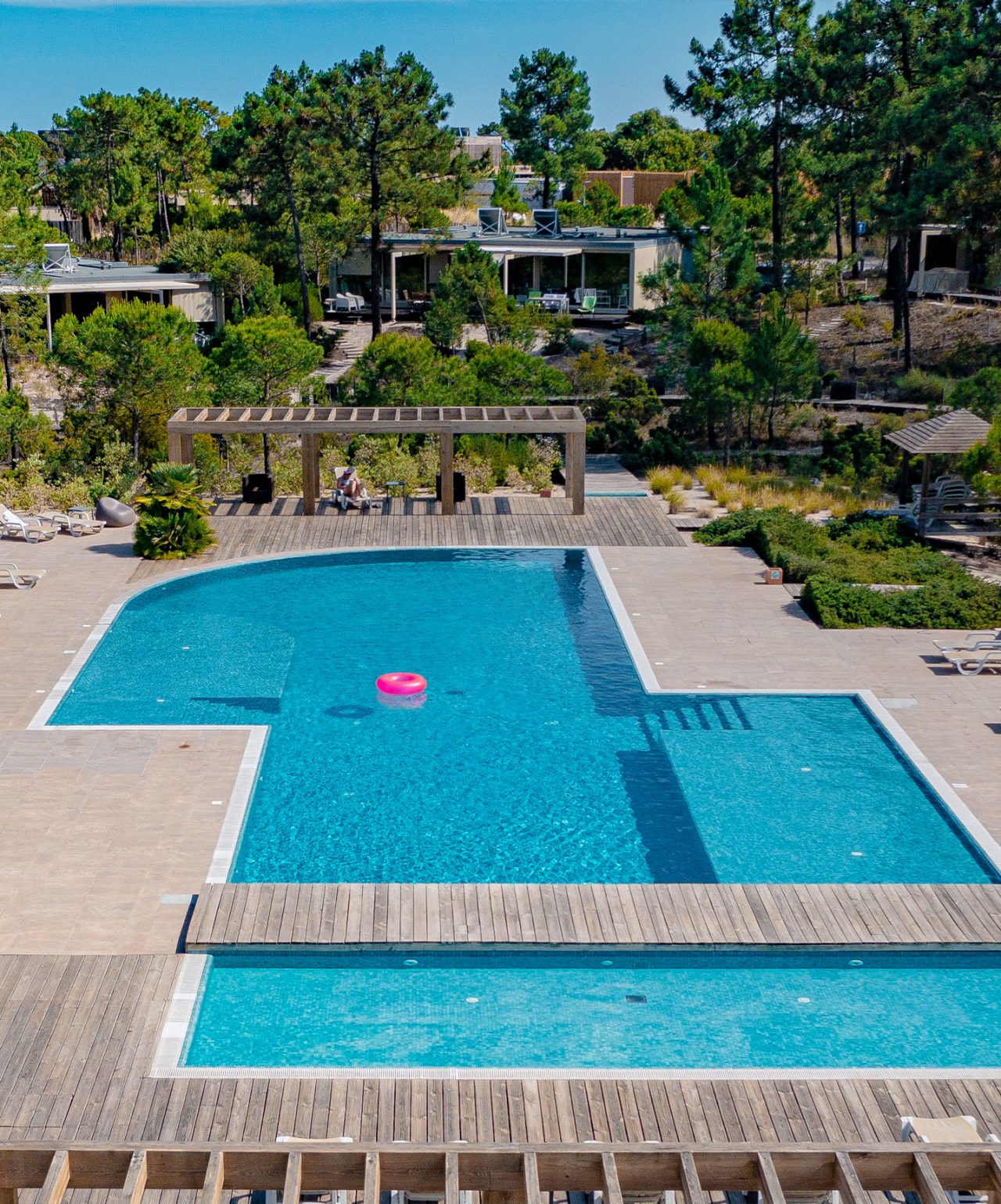 Piscina no Pestana Tróia, um Eco Resort no Alentejo, com uma bóia rosa no meio e natureza à volta