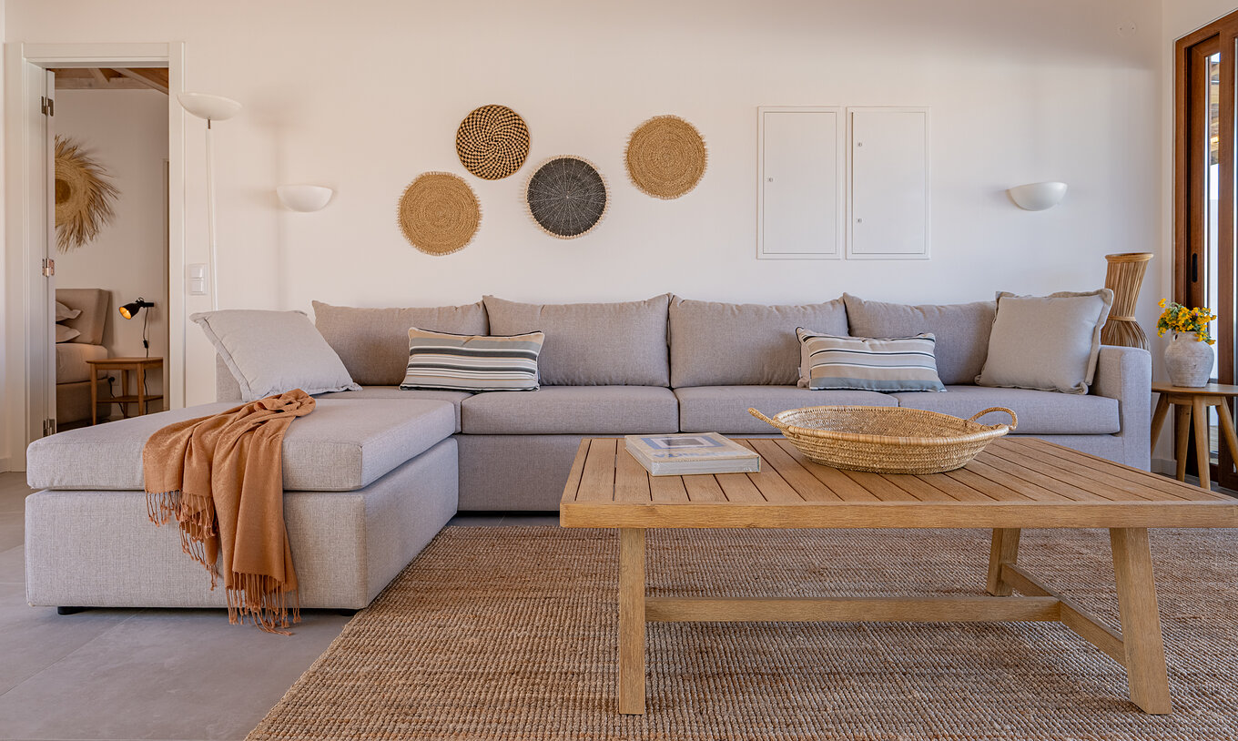 The Superior Villa at Pestana Comporta Village Residences has a living room with a gray sofa and a table