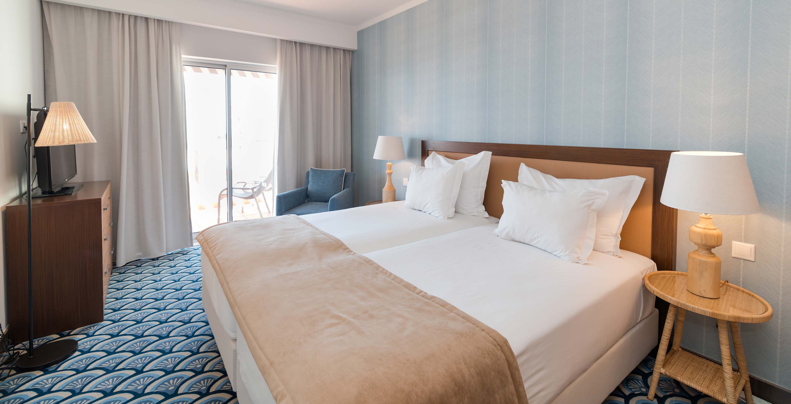 Apartment T1 Sea View at Pestana Alvor Beach Villas has a bedroom with two beds, a sofa and window with balcony