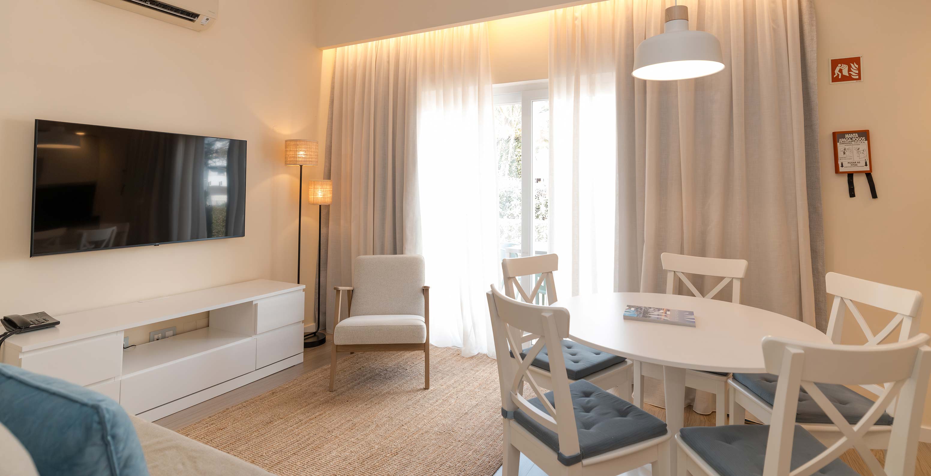 Villa 2 Bedrooms Superior Garden View at Pestana Alvor Beach Villas has living room with TV, air conditioning, dining table