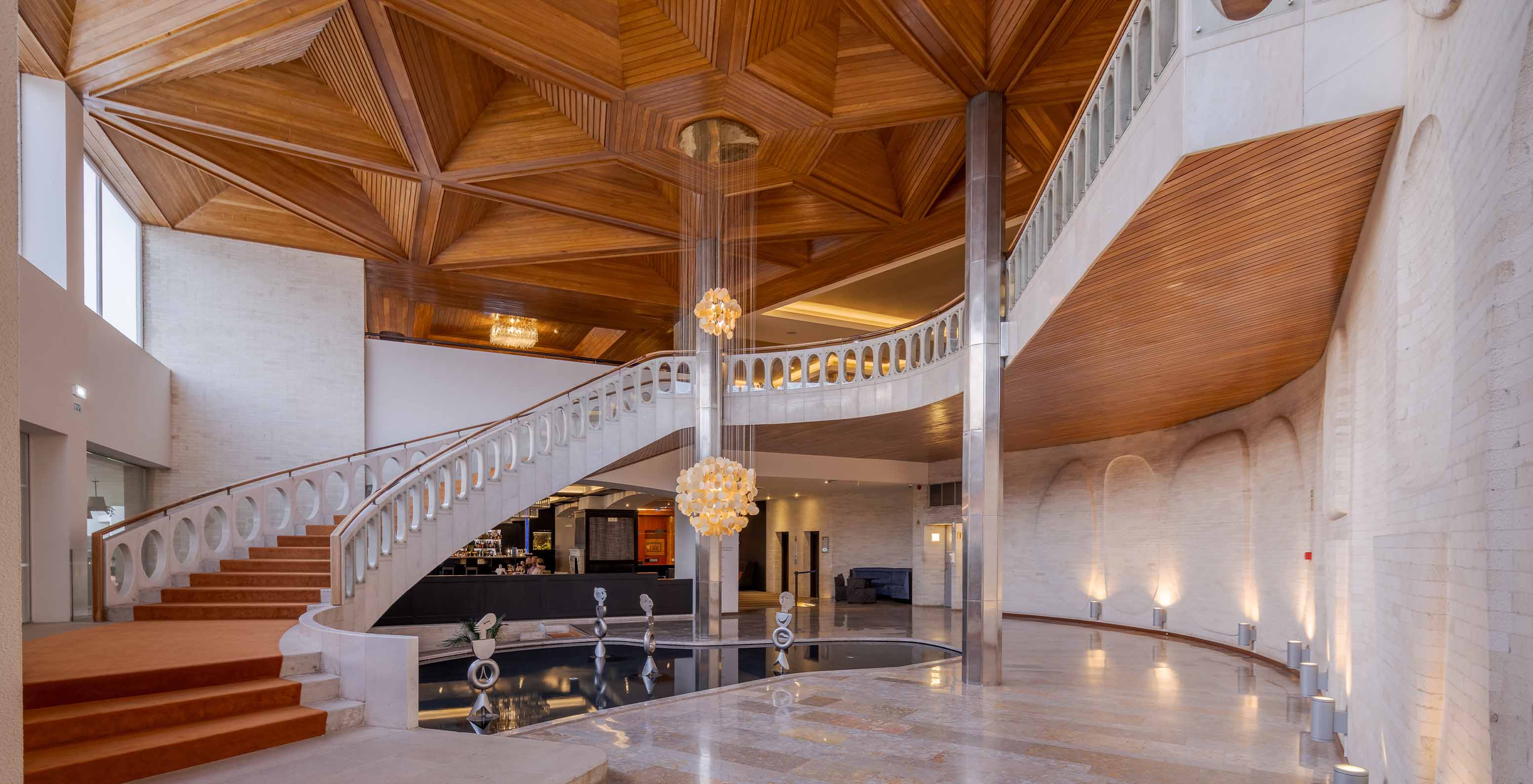 Light-toned staircase with an orange carpet in the lobby of Pestana Alvor Praia, Hotel with Spa and Pool