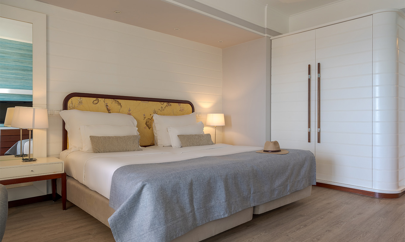 The Superior Sea View at Pestana Alvor Praia has two joined beds with bedside tables and a white wardrobe