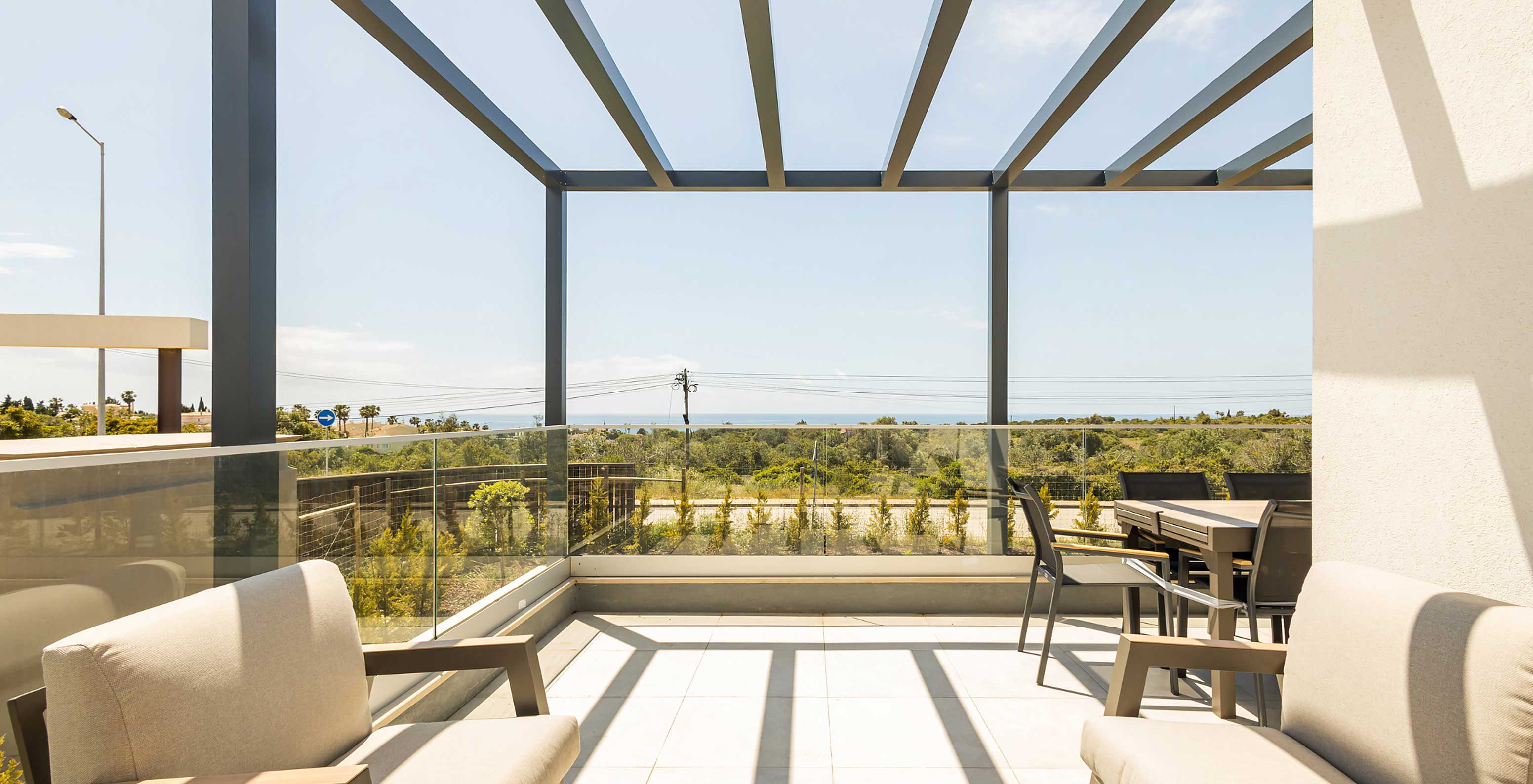 Pestana Valley Nature Village apartment with a terrace with sofas and a dining table