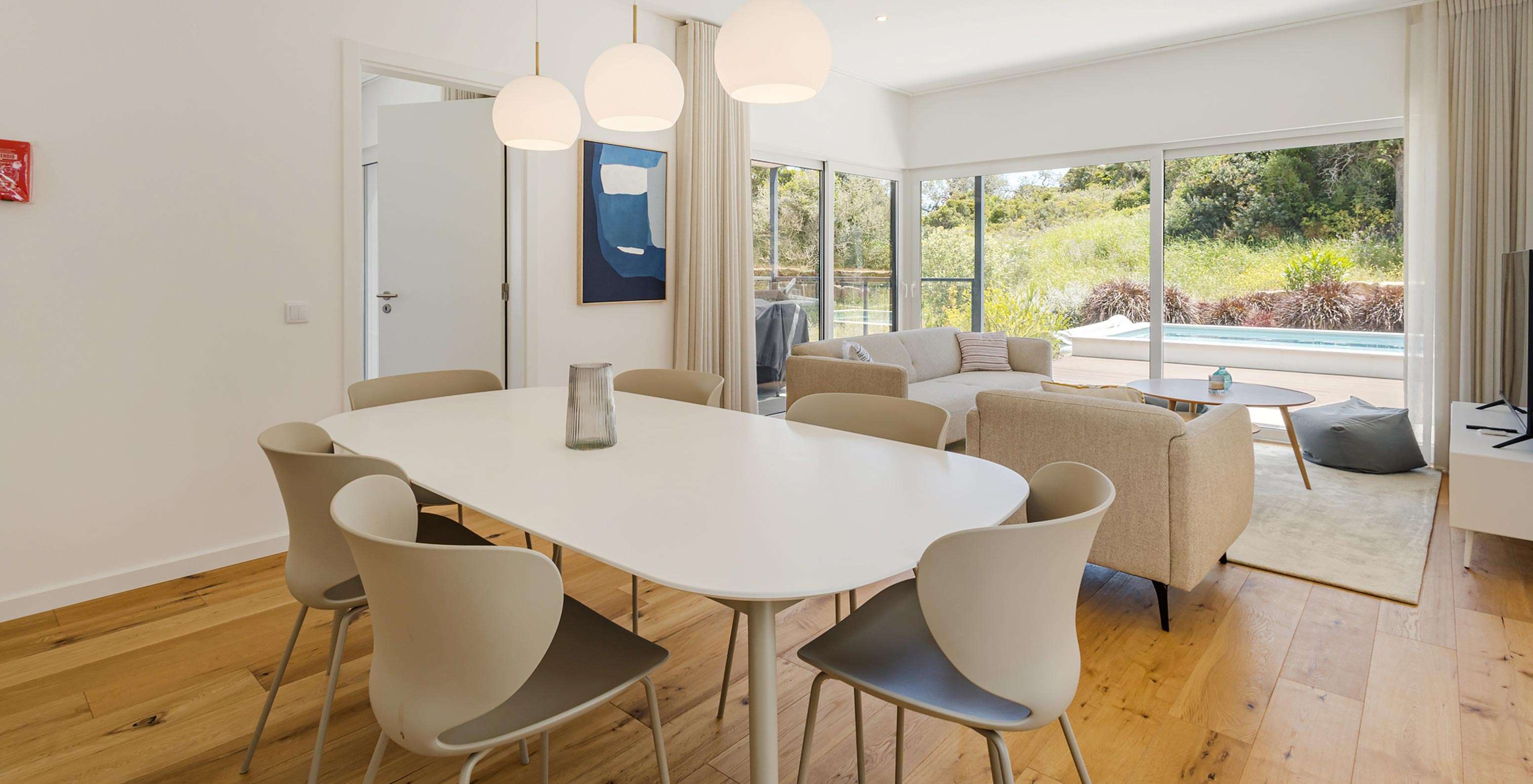 Pestana Valley Nature Village villa with several sofas with an outdoor view