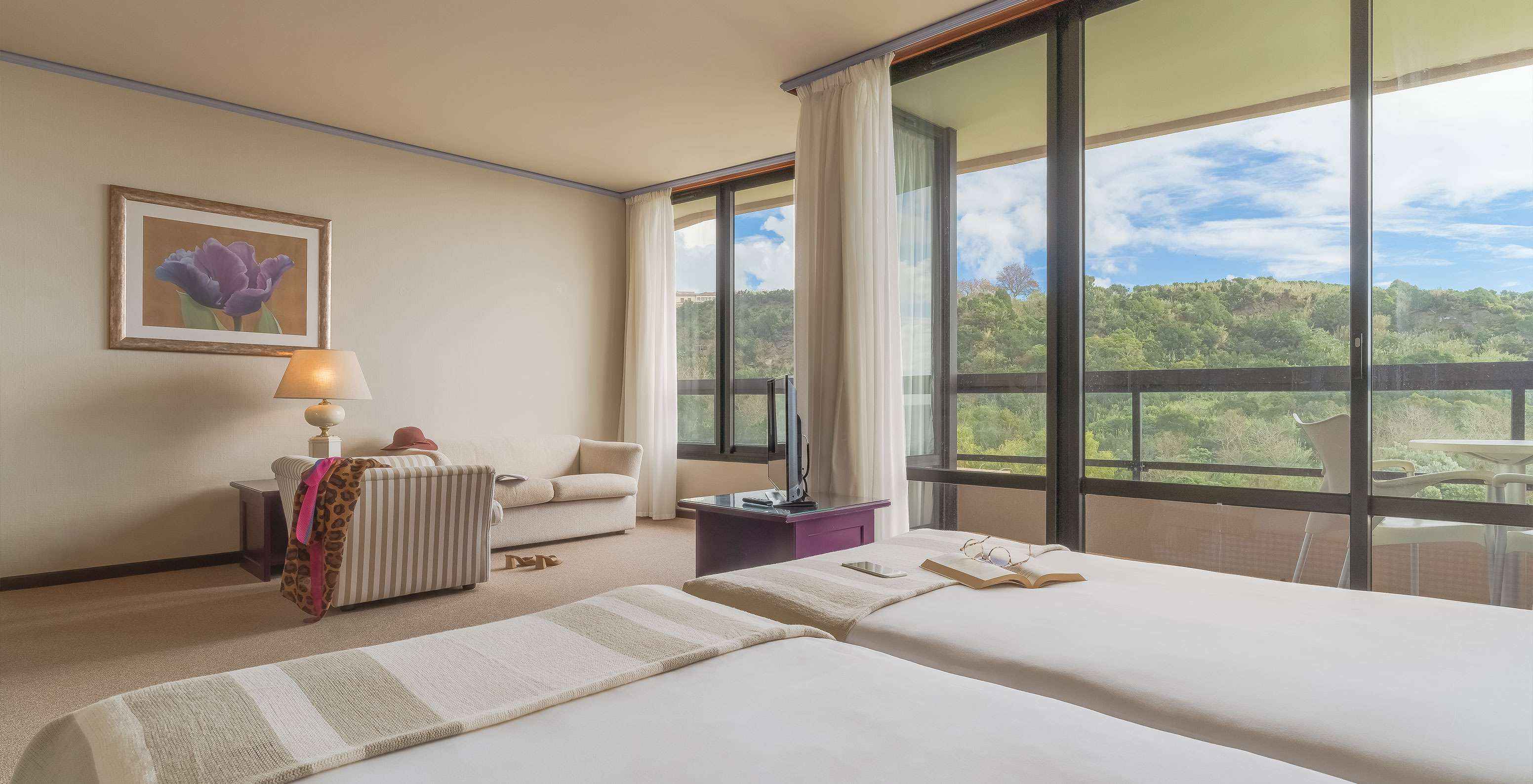 Junior Garden View Suite at Pestana Bahia Praia has a beautiful view of green landscapes, with access to the balcony