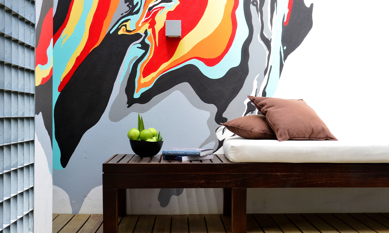 The Superior Room with Balcony at Pestana Cidadela Cascais has a wooden bench on the balcony and art on the wall