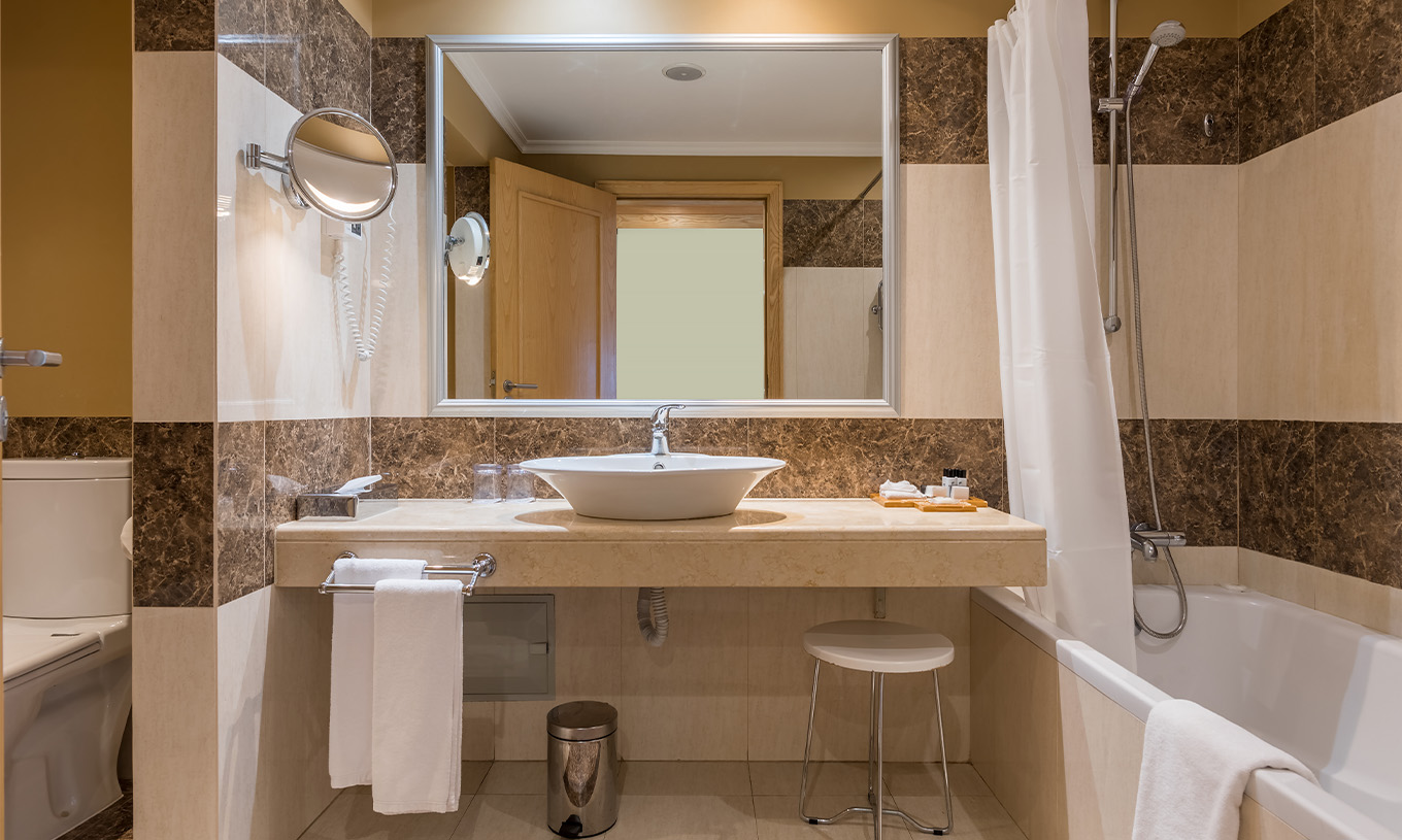 The Classic Double Room with Bay and Sea View at Pestana Carlton Madeira has a tiled bathroom, bathtub, and toilet