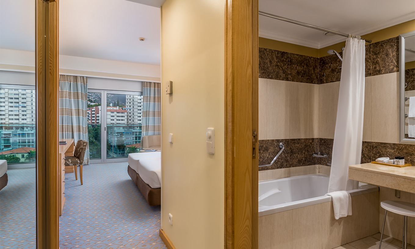 The Classic Double Room with City View at Pestana Carlton Madeira has a bathroom, large window, and a double bed