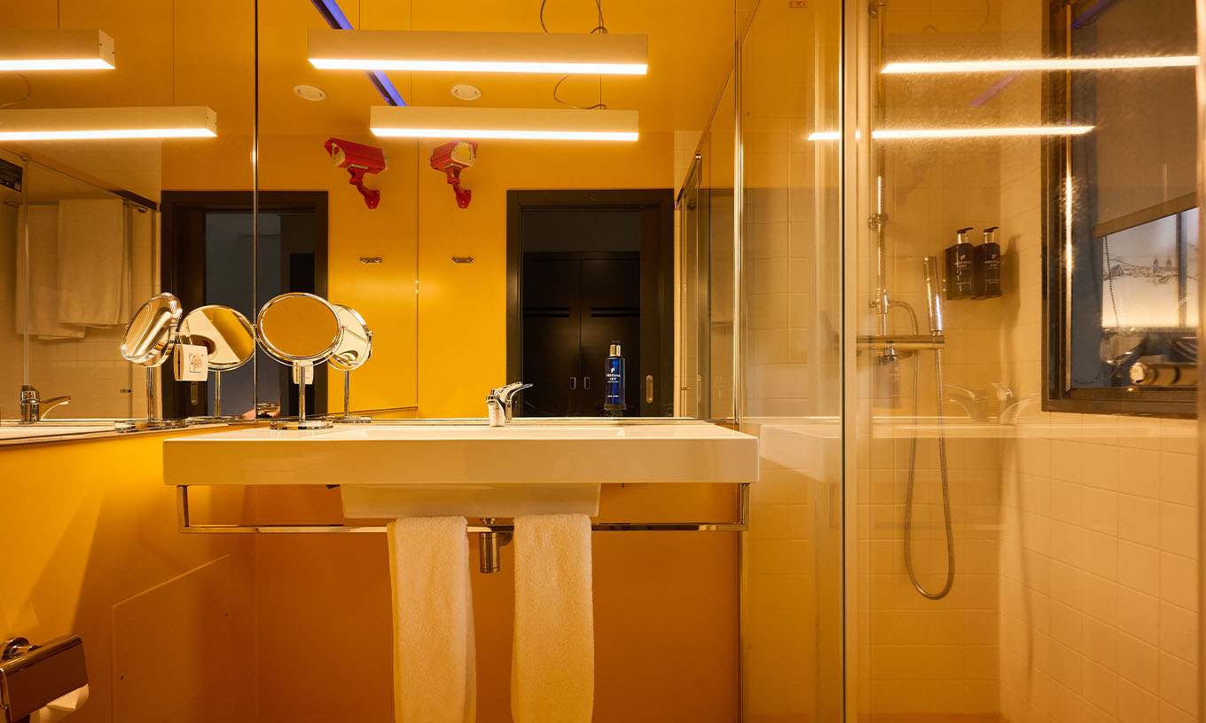 The CR7 Room at Pestana CR7 Funchal features a modern yellow bathroom with a shower