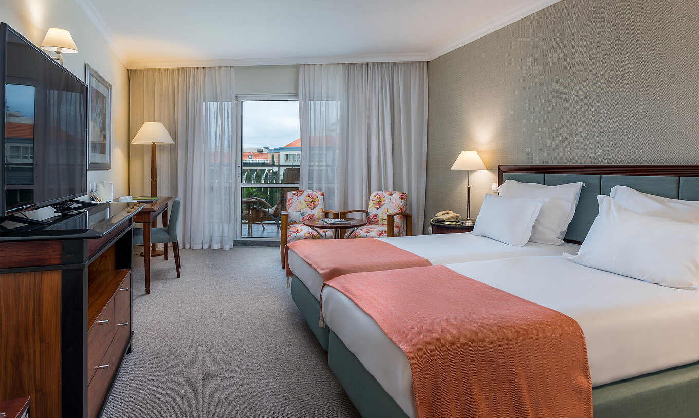 The Classic Sea Side Room at Pestana Grand has two single beds with bedside table, two armchairs
