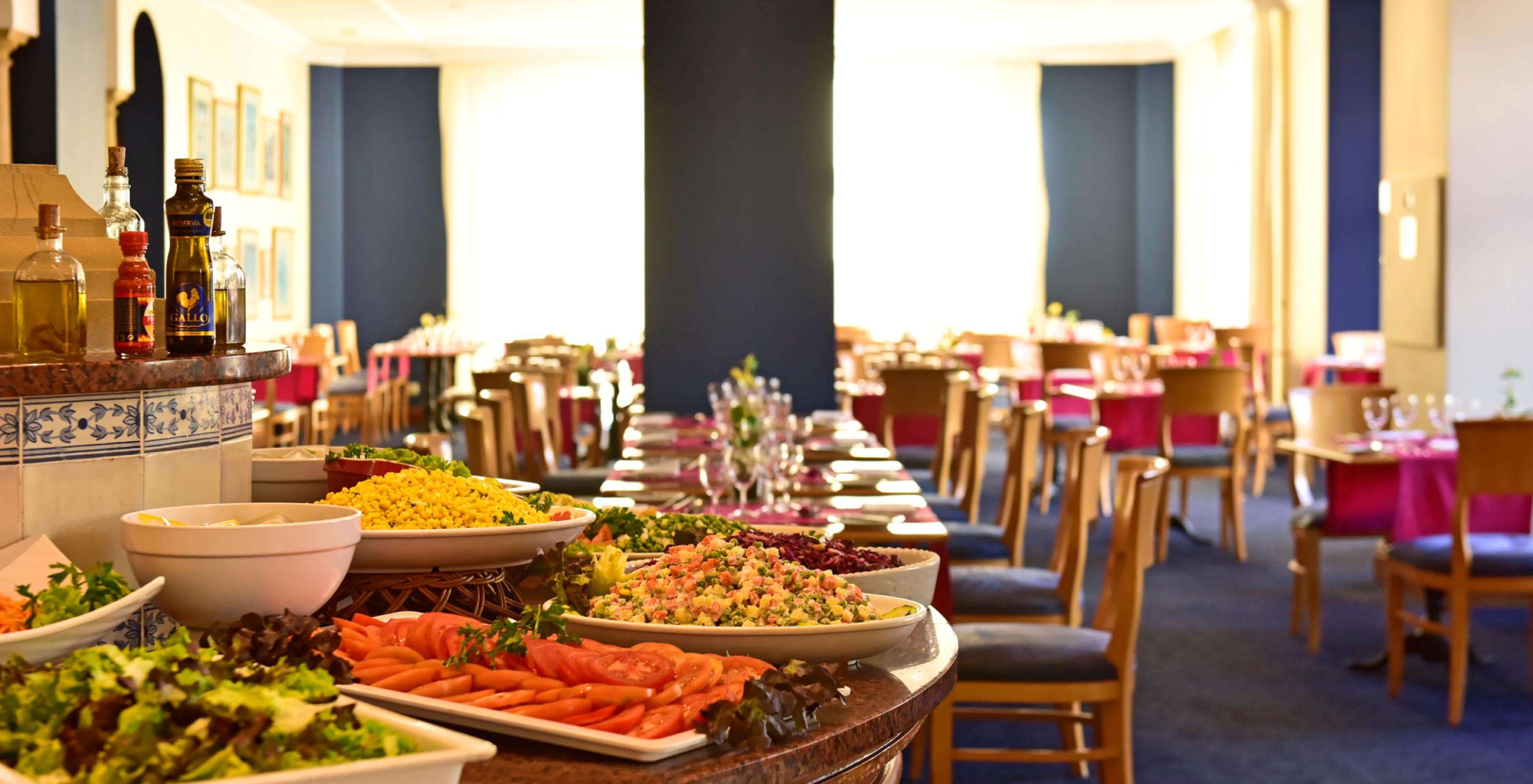 The restaurant A Vila, at the Hotel de Charme in Madeira has breakfast with a fruit buffet and tables