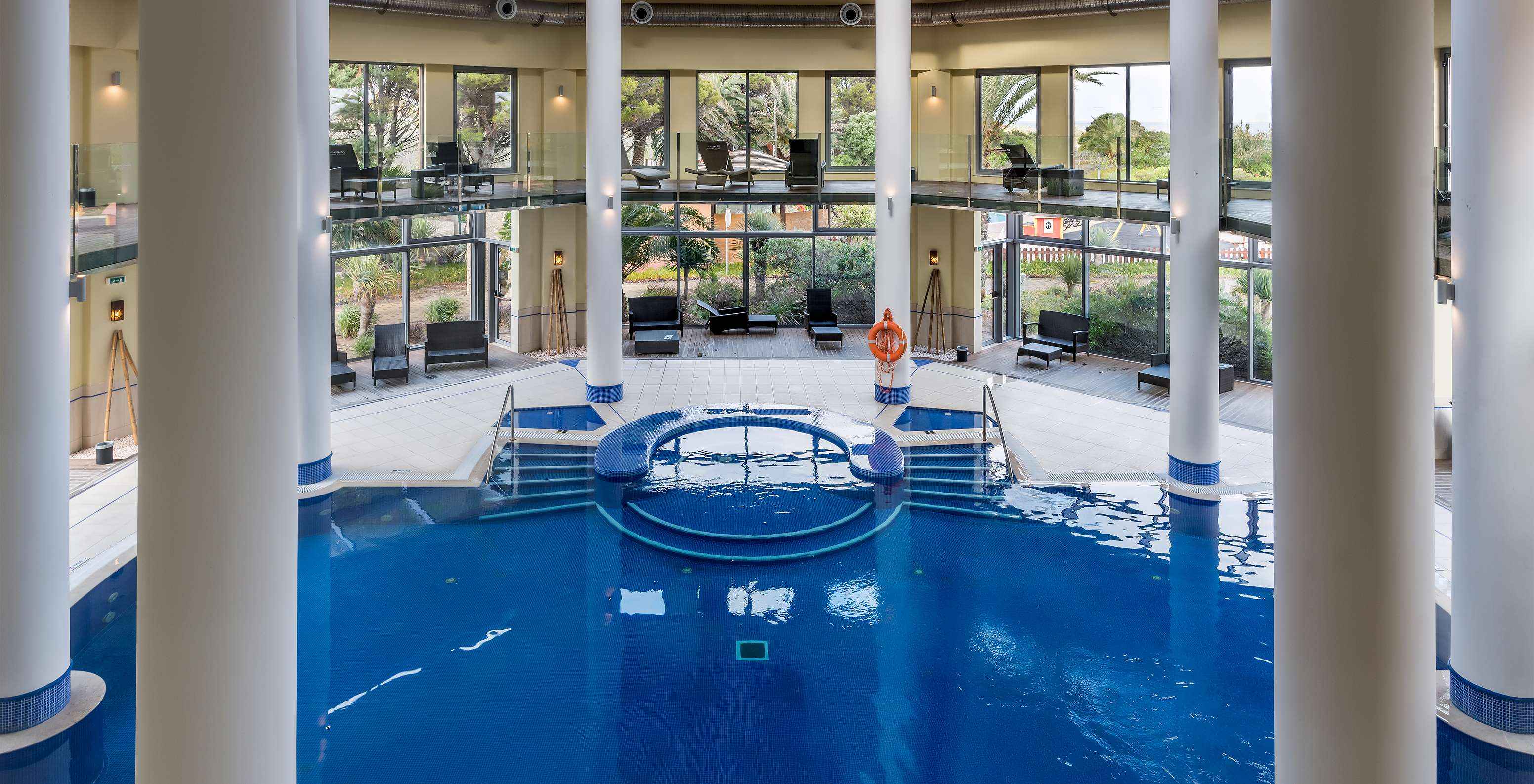 Indoor pool with loungers at Pestana Porto Santo, hotel with all-inclusive and spa in Porto Santo