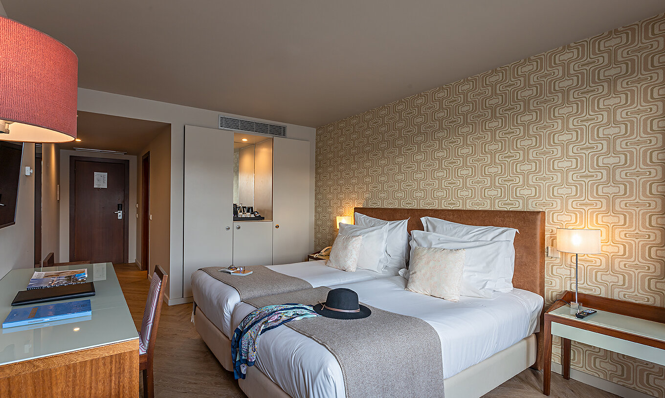 The Vintage River View at Pestana Vintage Porto has two single beds, a white wardrobe and a desk