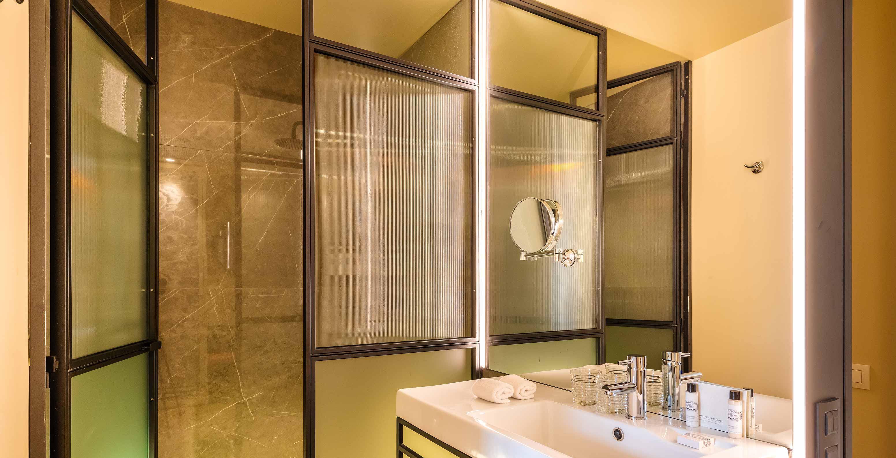 The Superior Plaza Mayor at Pestana Plaza Mayor Madrid has bathroom with shower, washbasin, mirrors