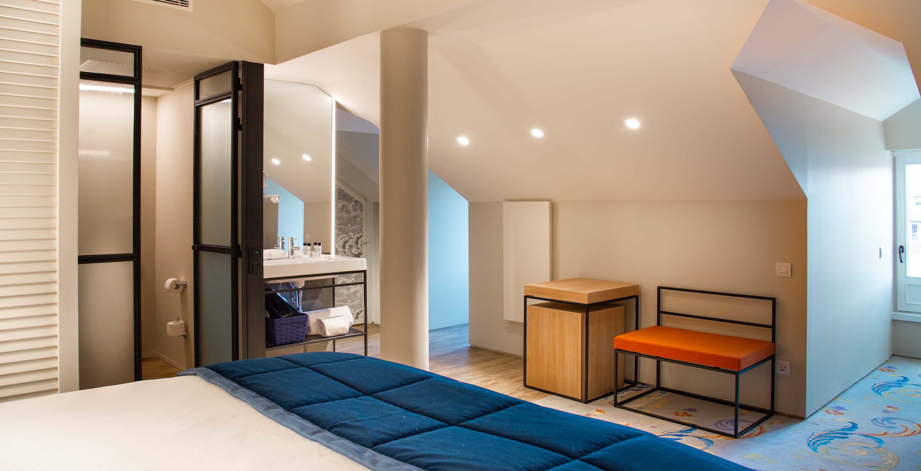 The Loft at Pestana Collection Plaza Mayor has a double bed, a sink inside the room and a side table