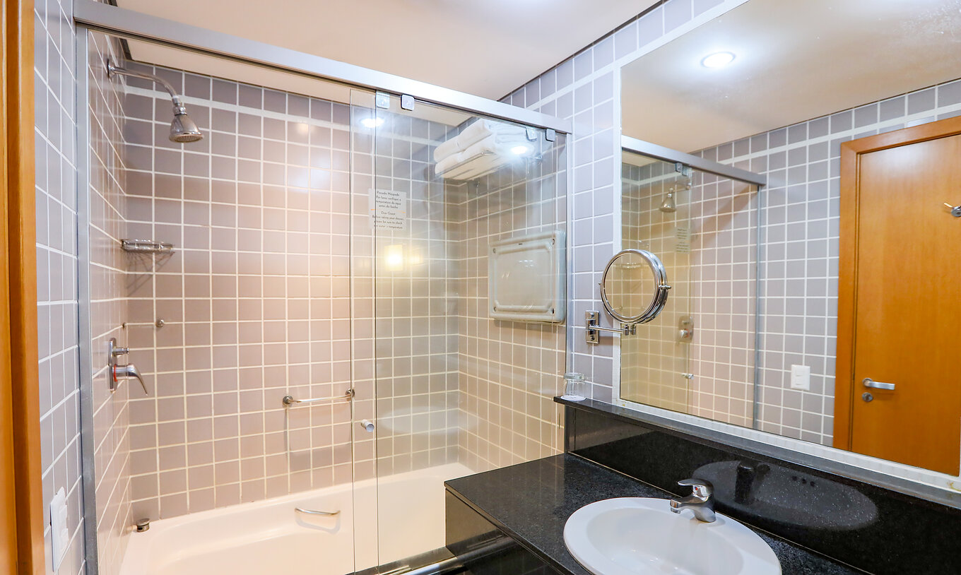 The Family Room at Pestana Curitiba has a bathroom with a bathtub and a black countertop with a sink