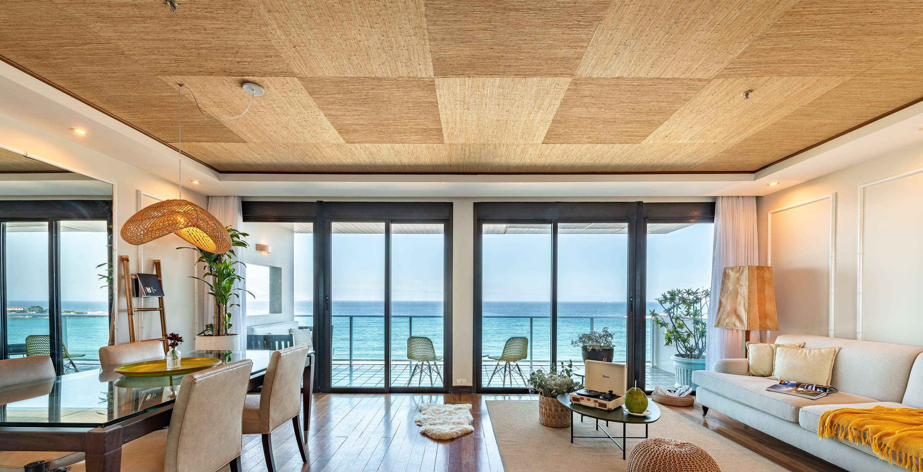 The Presidential Suite of Pestana Rio Atlântica has a living room with two large windows and a balcony with sea view