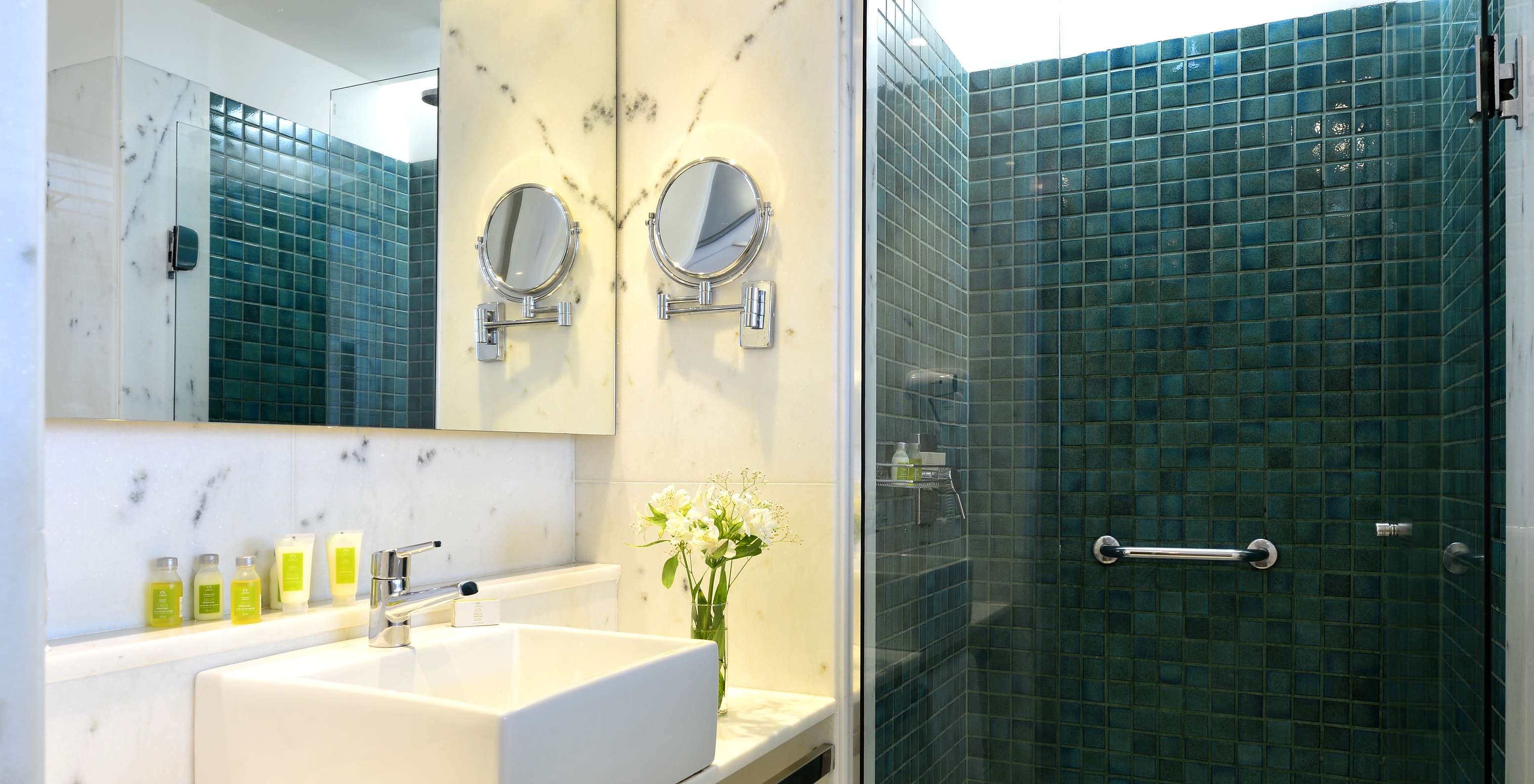 The Twin Standard of Pestana Rio Atlântica has a bathroom with shower, sink with mirror, and amenities