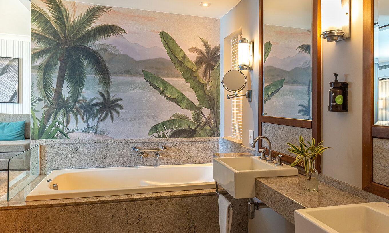 The Suite Beach Front at Pestana Rio Atlântica has a bathroom with marble tub, double sinks and mirror.