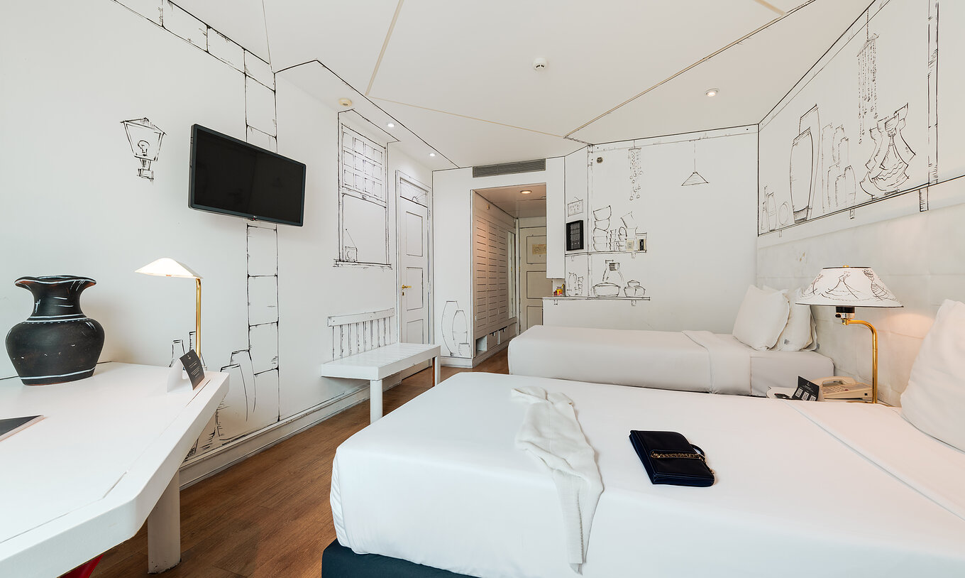 The Art Room of Pestana São Paulo has two beds and black and white paintings of utensils by artist Elano Passos