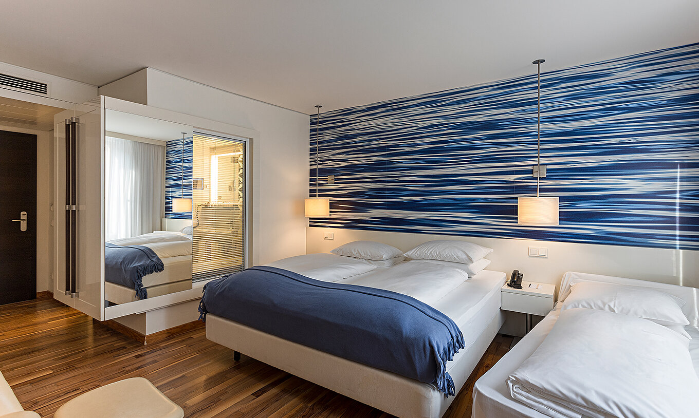 Family Deluxe is a spacious room with blue-toned decor
