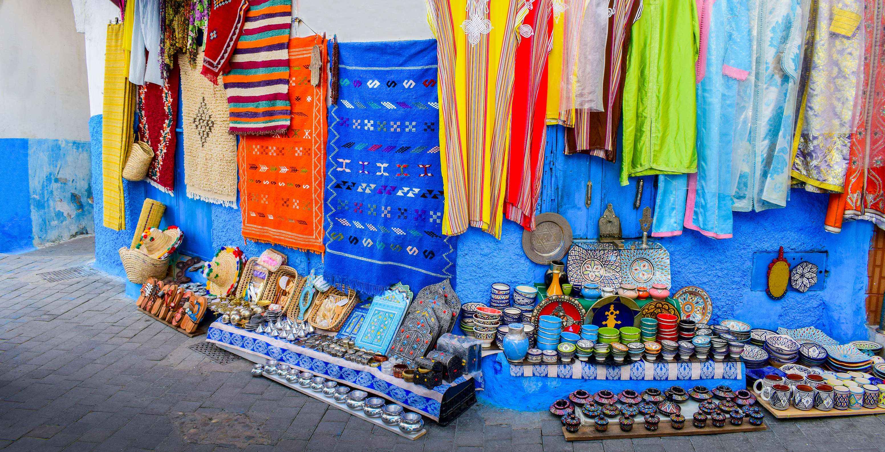 Moroccan products like clothes, pottery, shoes, and carpets typical of Tangier's traditional markets