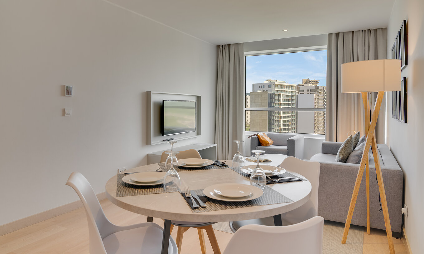 The Family Premium Suite of Pestana Tanger City Center features a living room with television, sofa, and dining table