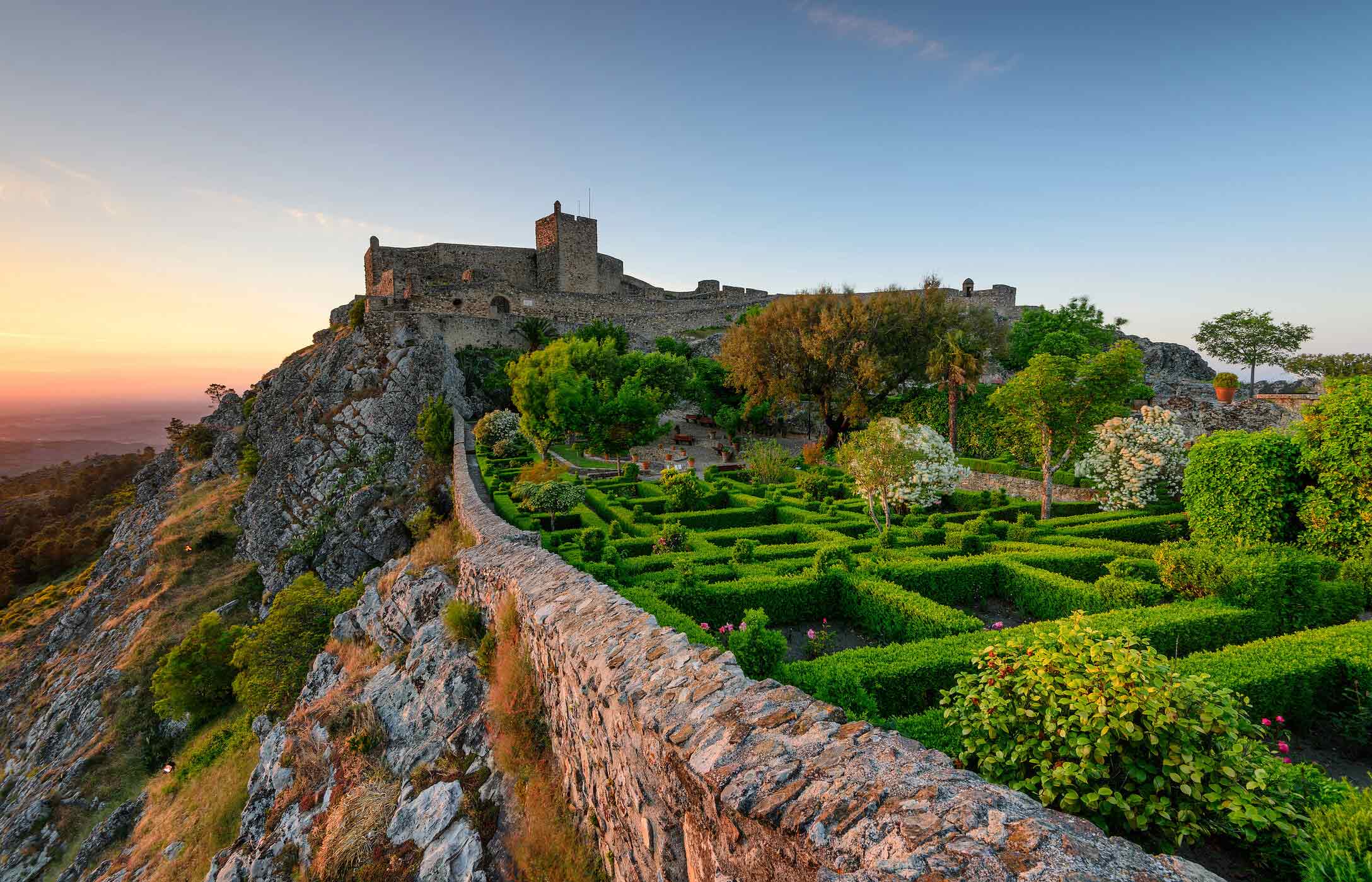 Panoramic view of Marvão Castle, situated on top of a hill, surrounded by gardens and overlooking the plain
