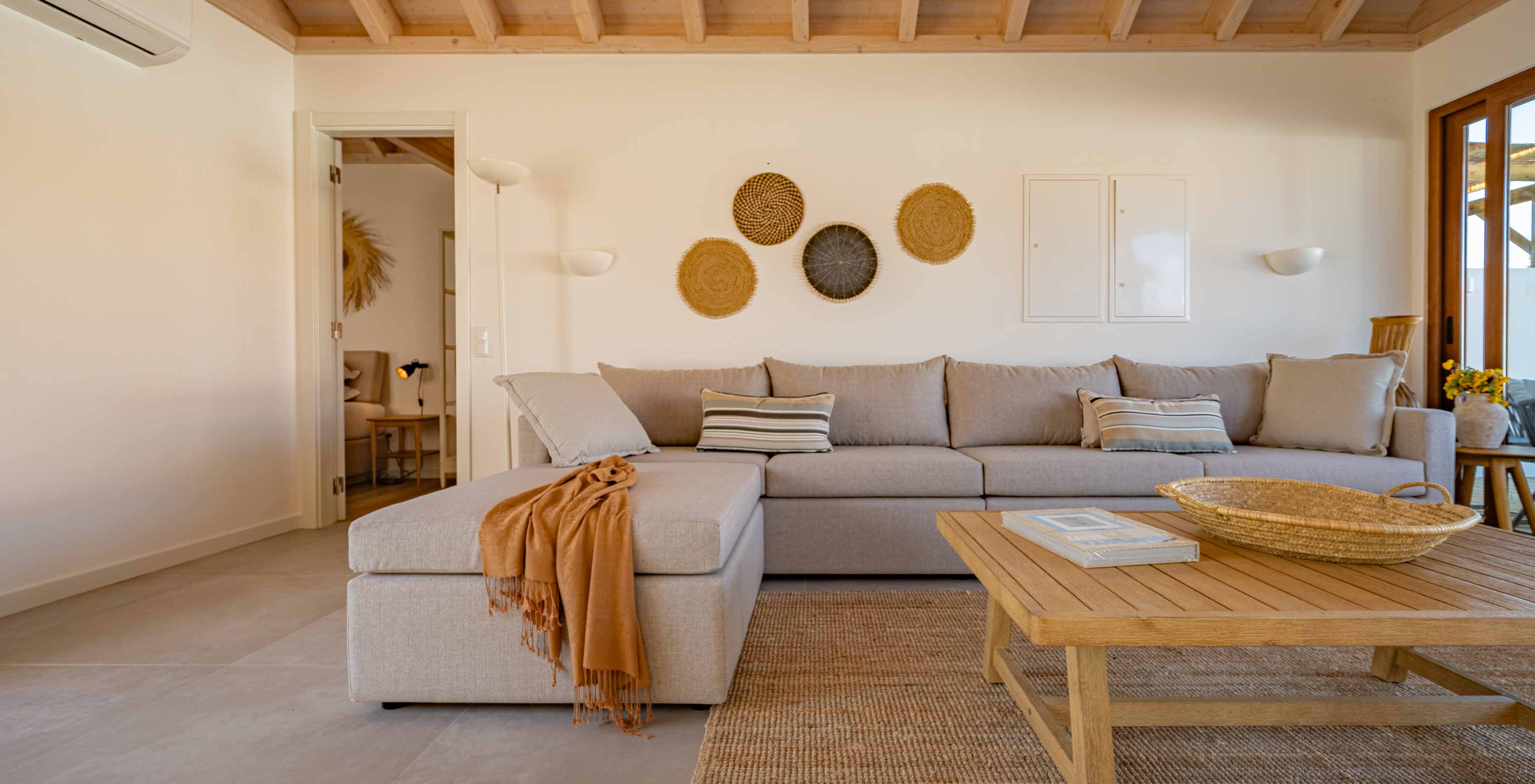 The Superior Green Villa at Pestana Comporta Village Residences has a living room with a gray sofa and a table