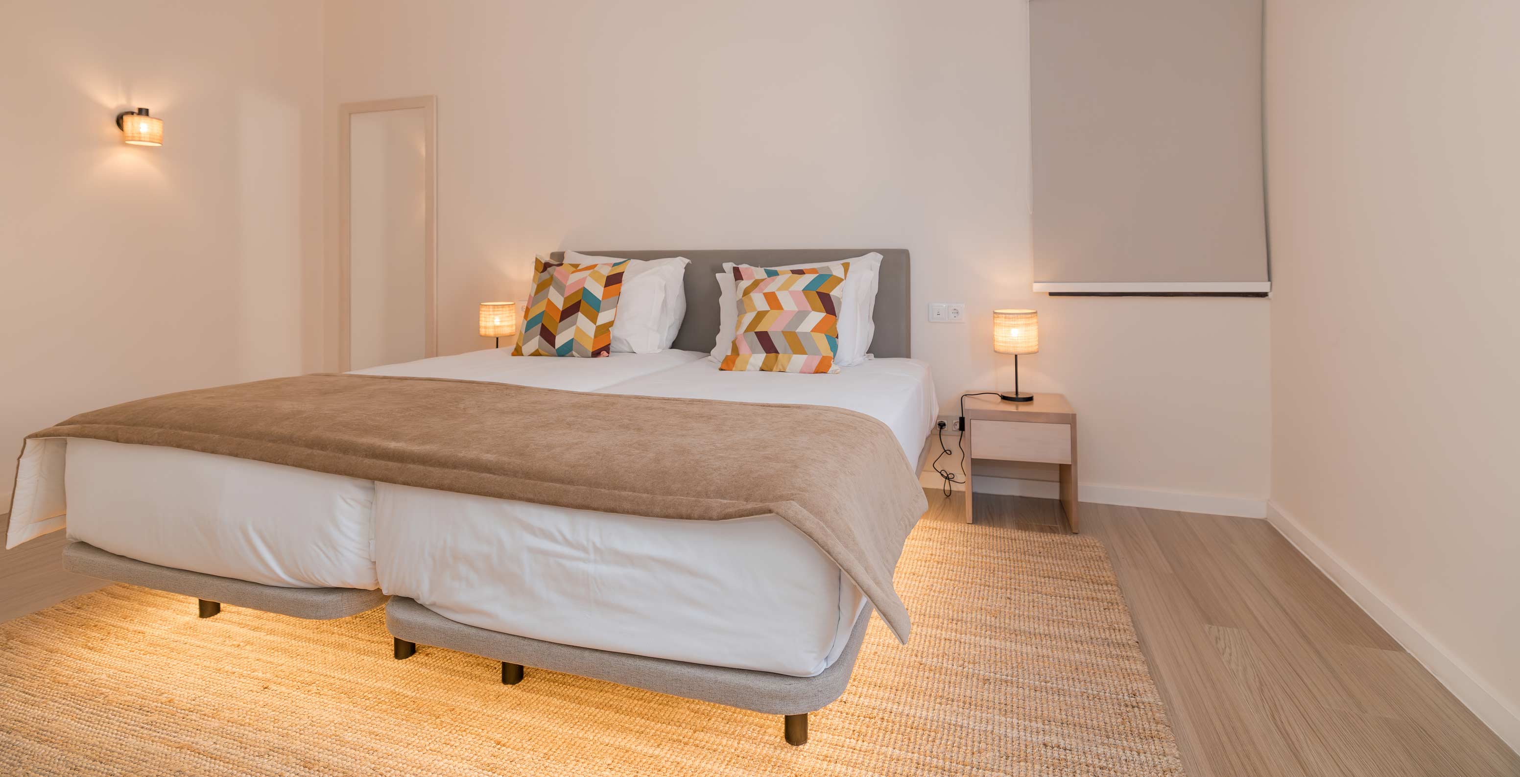 Villa 2 Bedrooms Premium at Pestana Alvor Beach Villas has a bedroom with two beds, bedside table and air conditioning