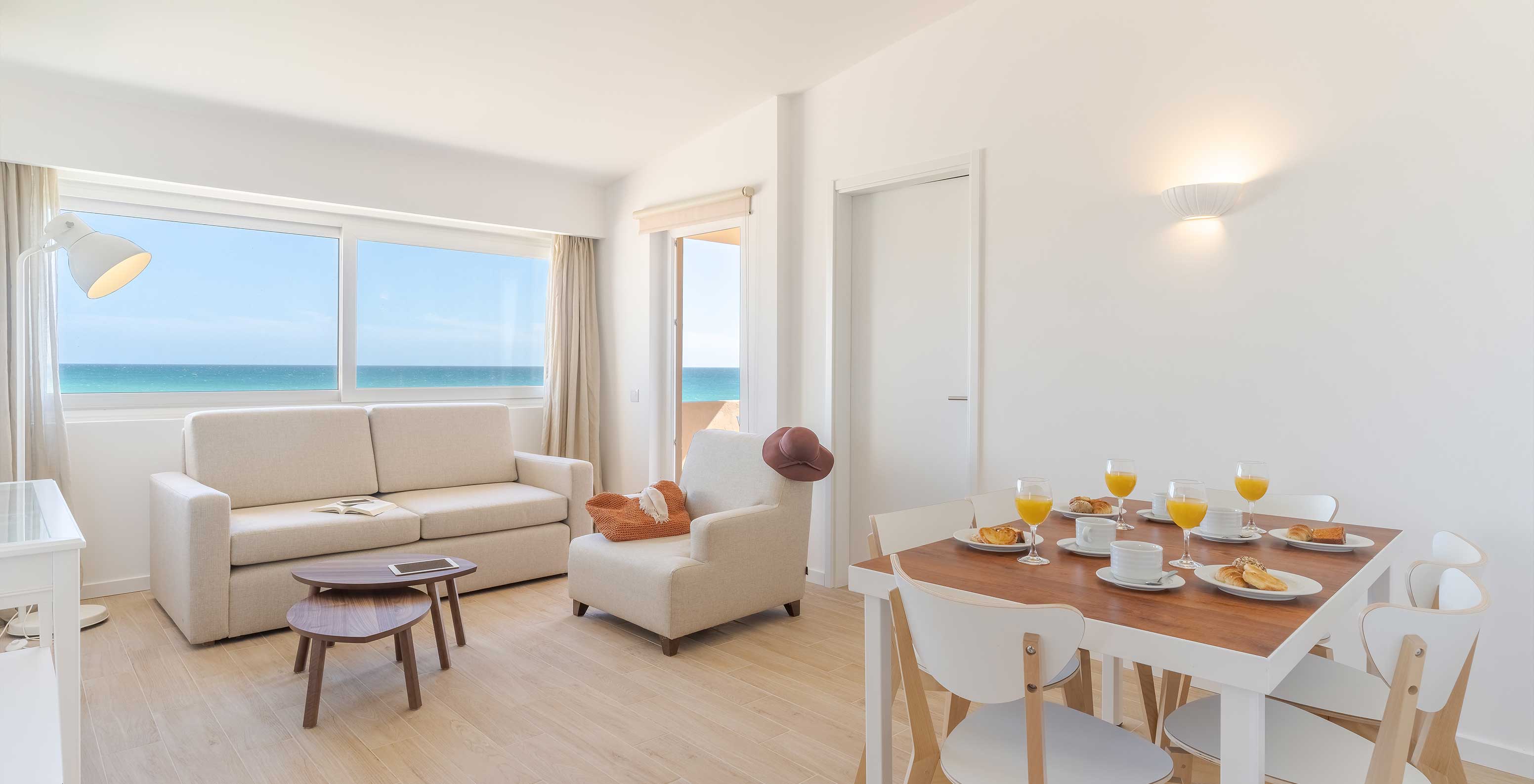 The 3 Bedroom Premium Sea View Villa at Pestana Alvor Beach Villas has a living room with sofas and a tabl