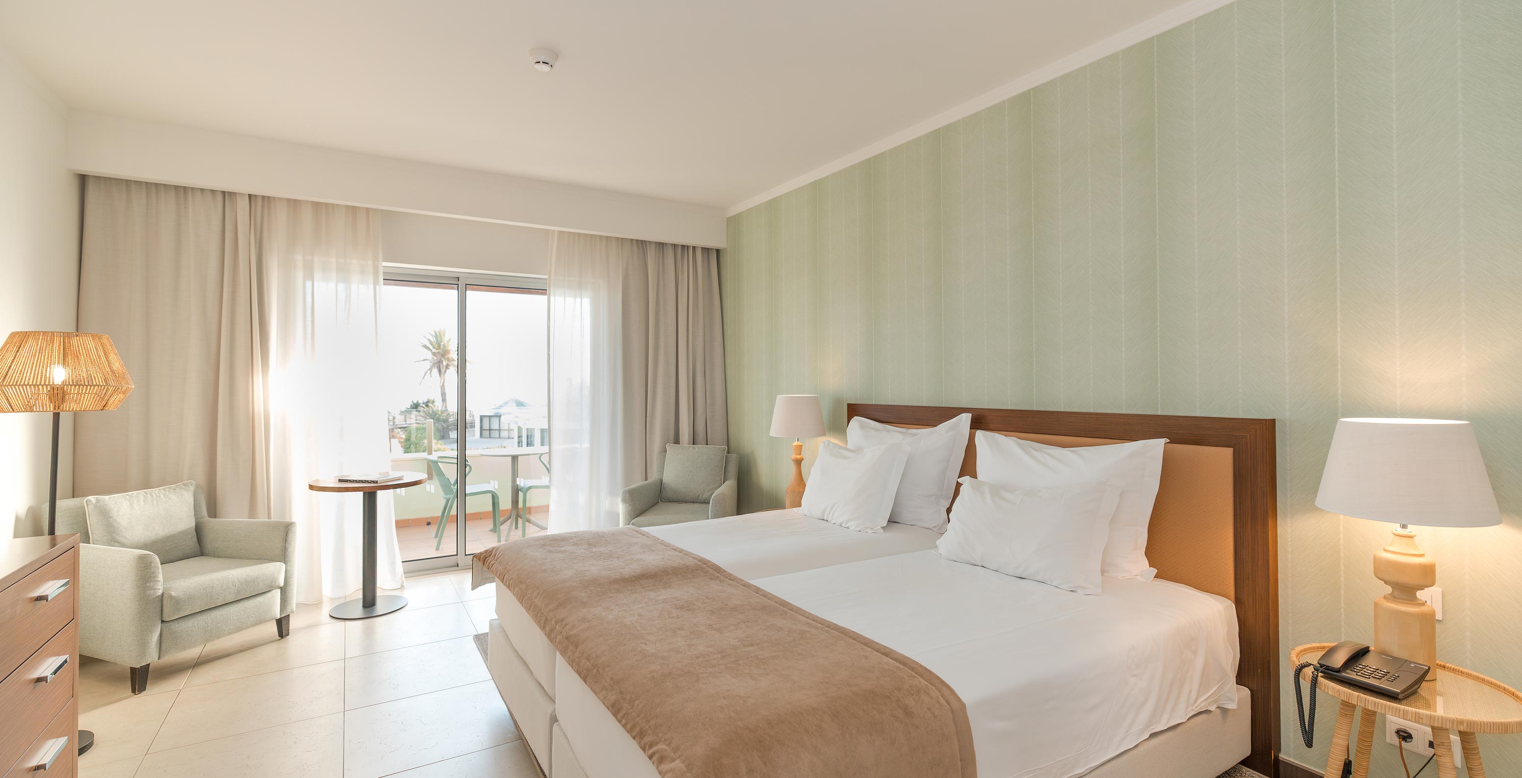 Studio Sea View at Pestana Alvor Beach Villas has two beds, two bedside tables and window with balcony access