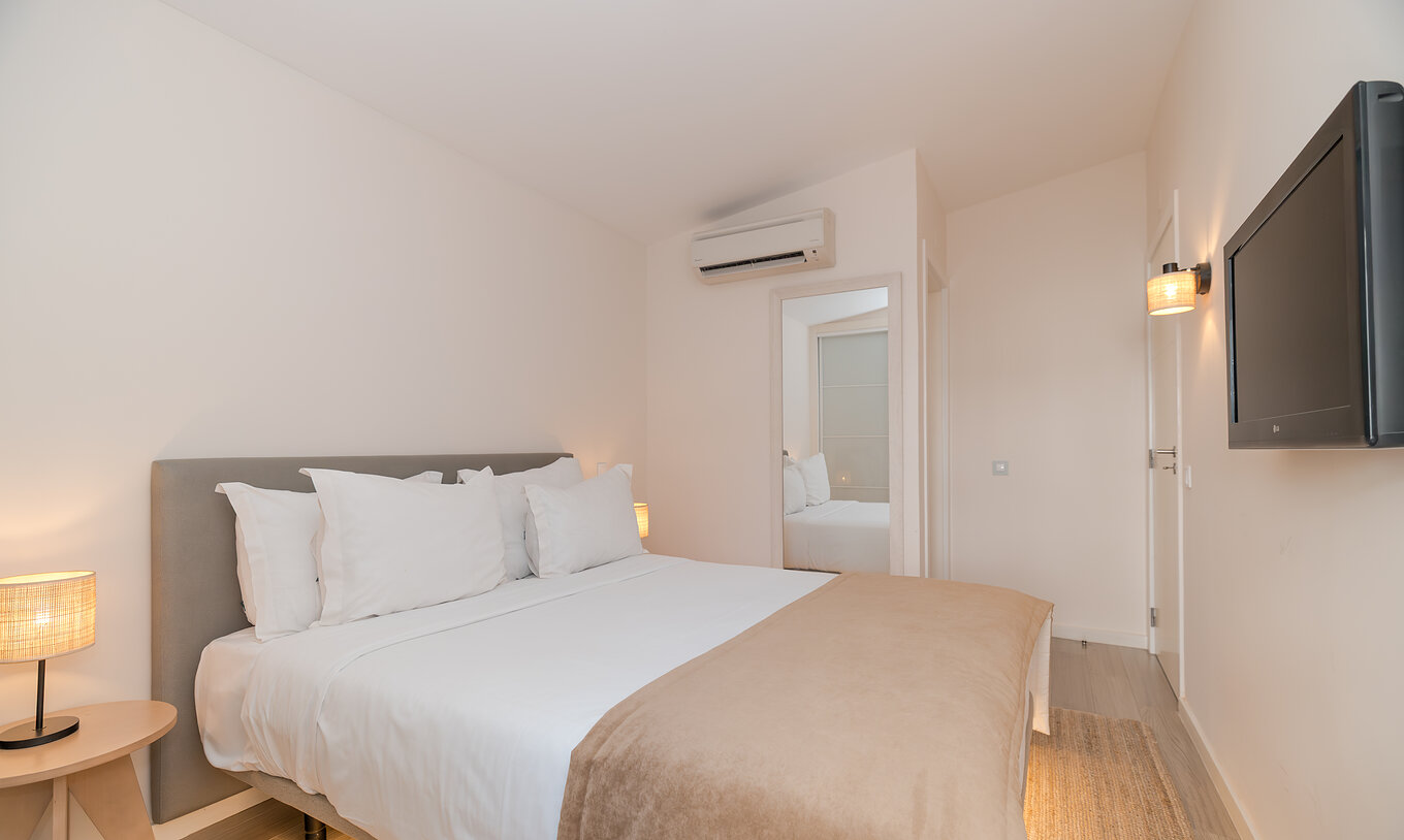 Villa 2 Bedrooms Superior Garden View at Pestana Alvor Beach Villas has a bedroom with double bed and TV