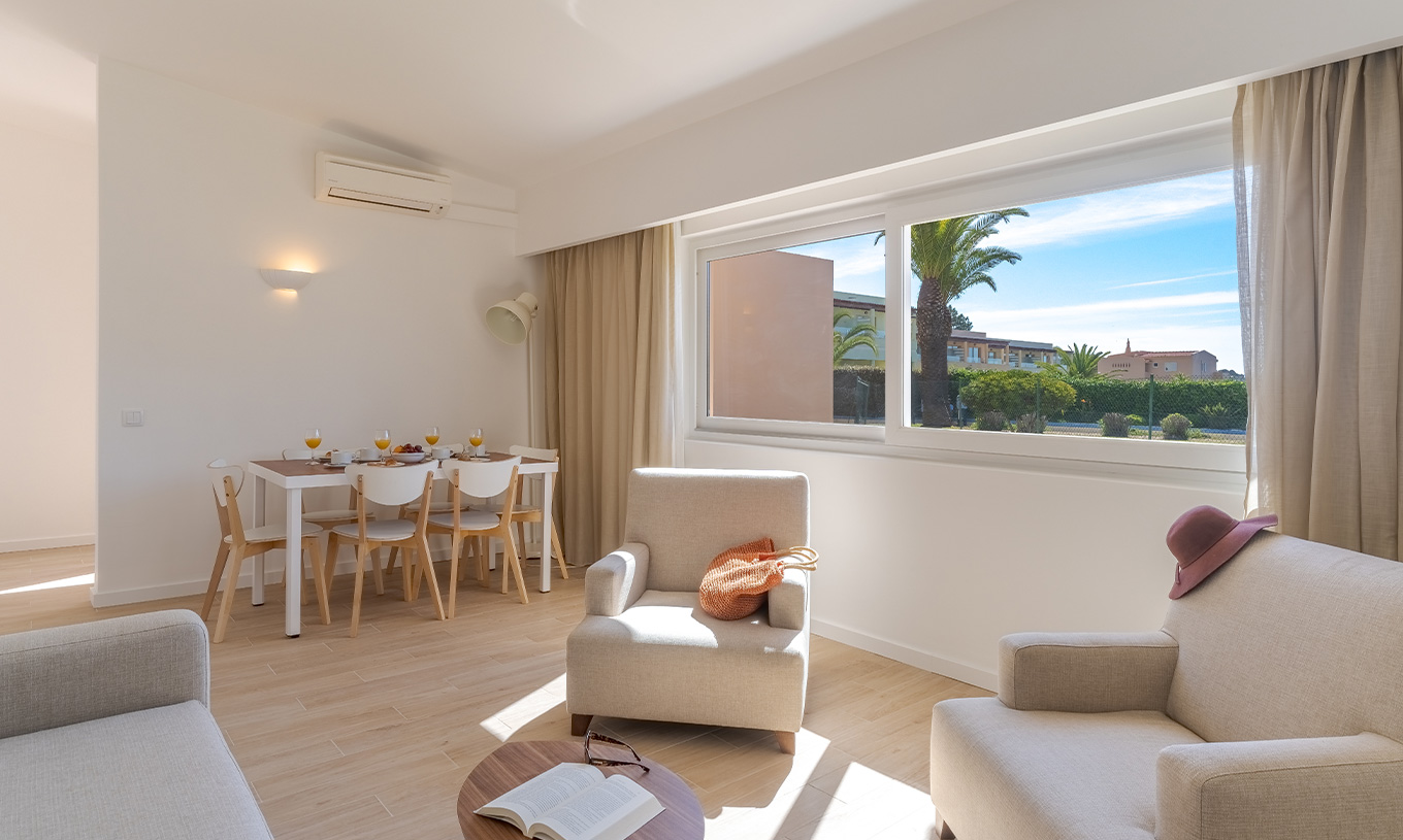 The 3 Bedroom Garden View Villa at Pestana Alvor Beach Villas has a living room with armchairs and a table