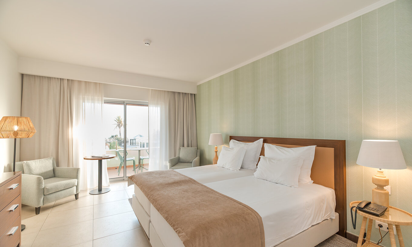 Studio Sea View at Pestana Alvor Beach Villas has two beds, two bedside tables and window with balcony access