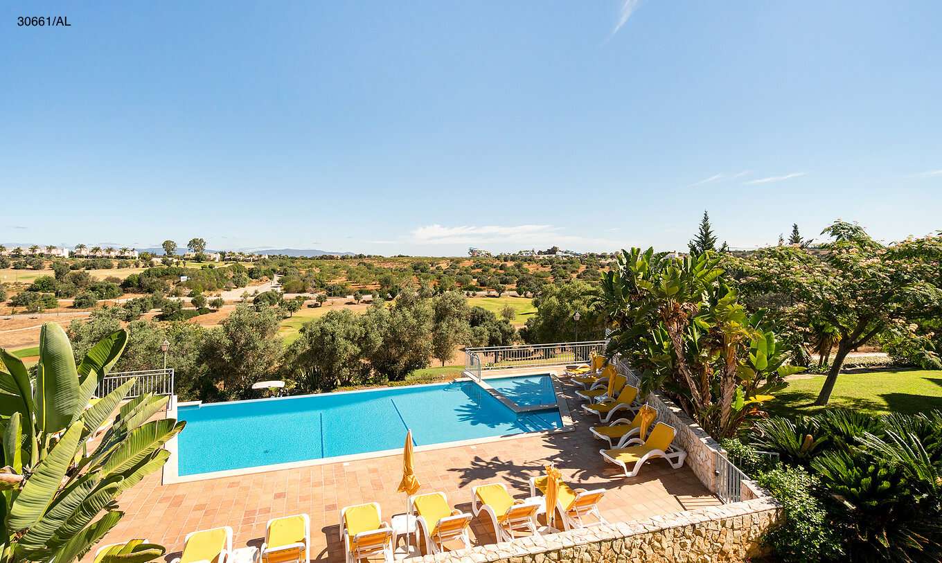 The Pestana Carvoeiro Golf T1 Superior Apartment has an outdoor pool with yellow loungers around it