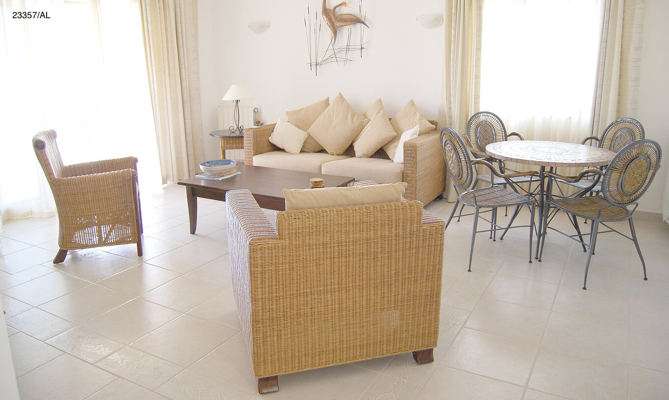 The Pestana Carvoeiro Golf T2 Standard Apartment has a living room with a sofa, armchairs, and dining table