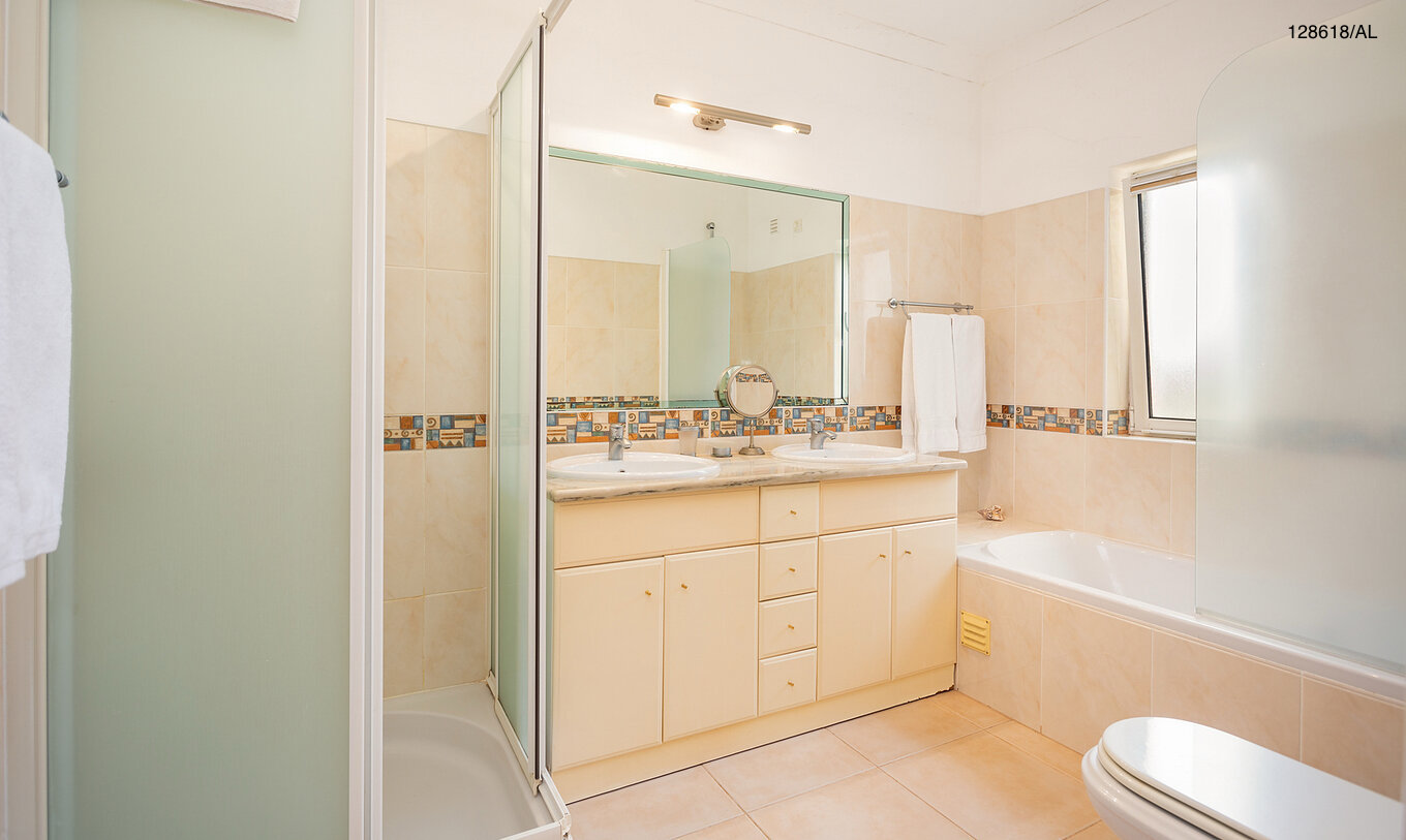 The Pestana Carvoeiro Golf V3 Superior Villa has a bathroom with a bathtub, shower, and sink with a mirror