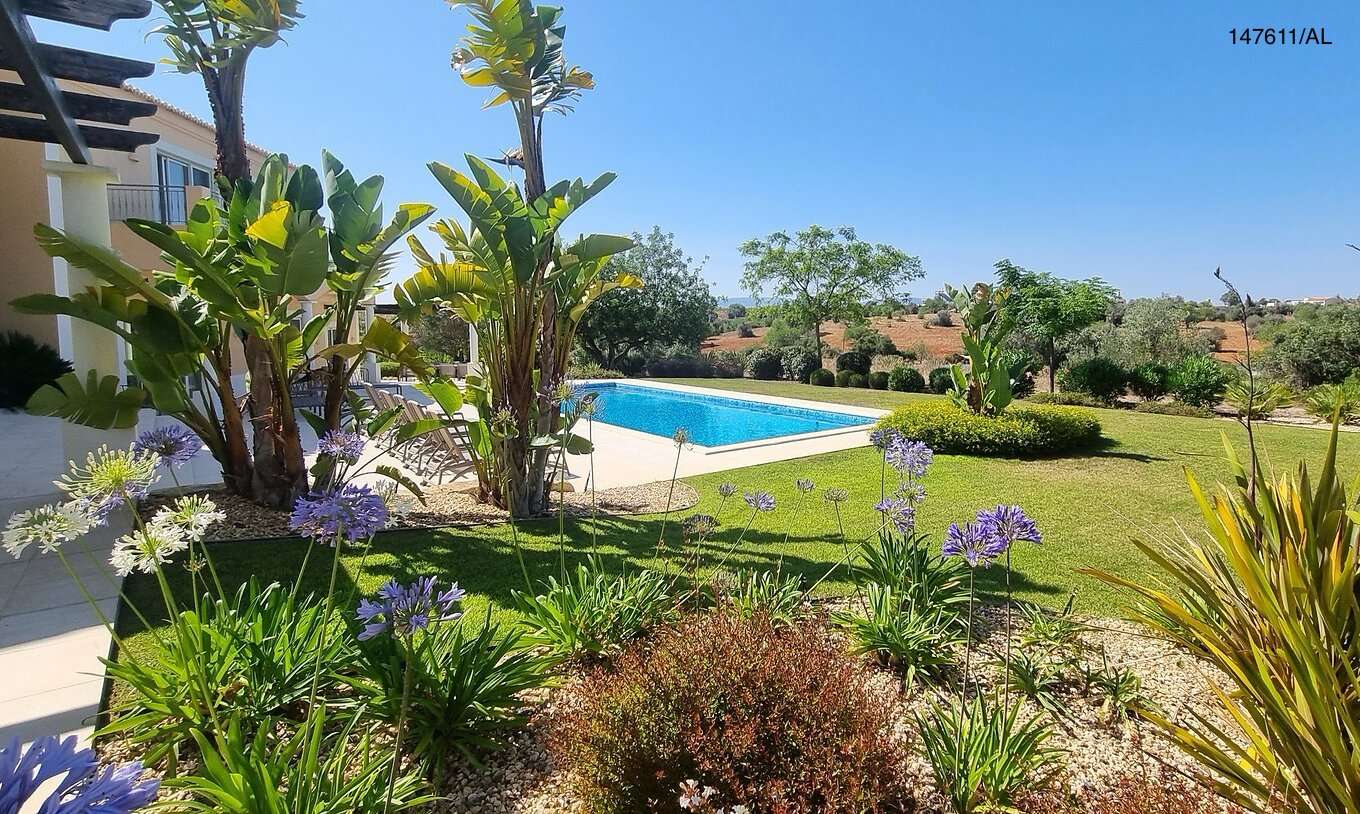 The Pestana Carvoeiro Golf V5 Superior Villa has an exterior patio with a pool, grass, and trees around it