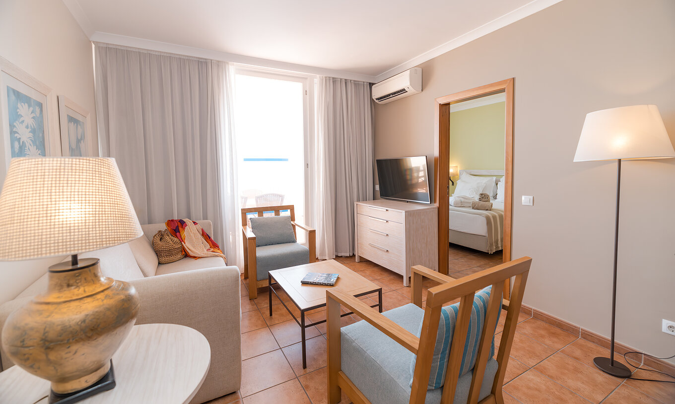 The Superior Sea View Suite at Pestana Viking has a living room with sofa, armchairs, TV, air conditioning and balcony access