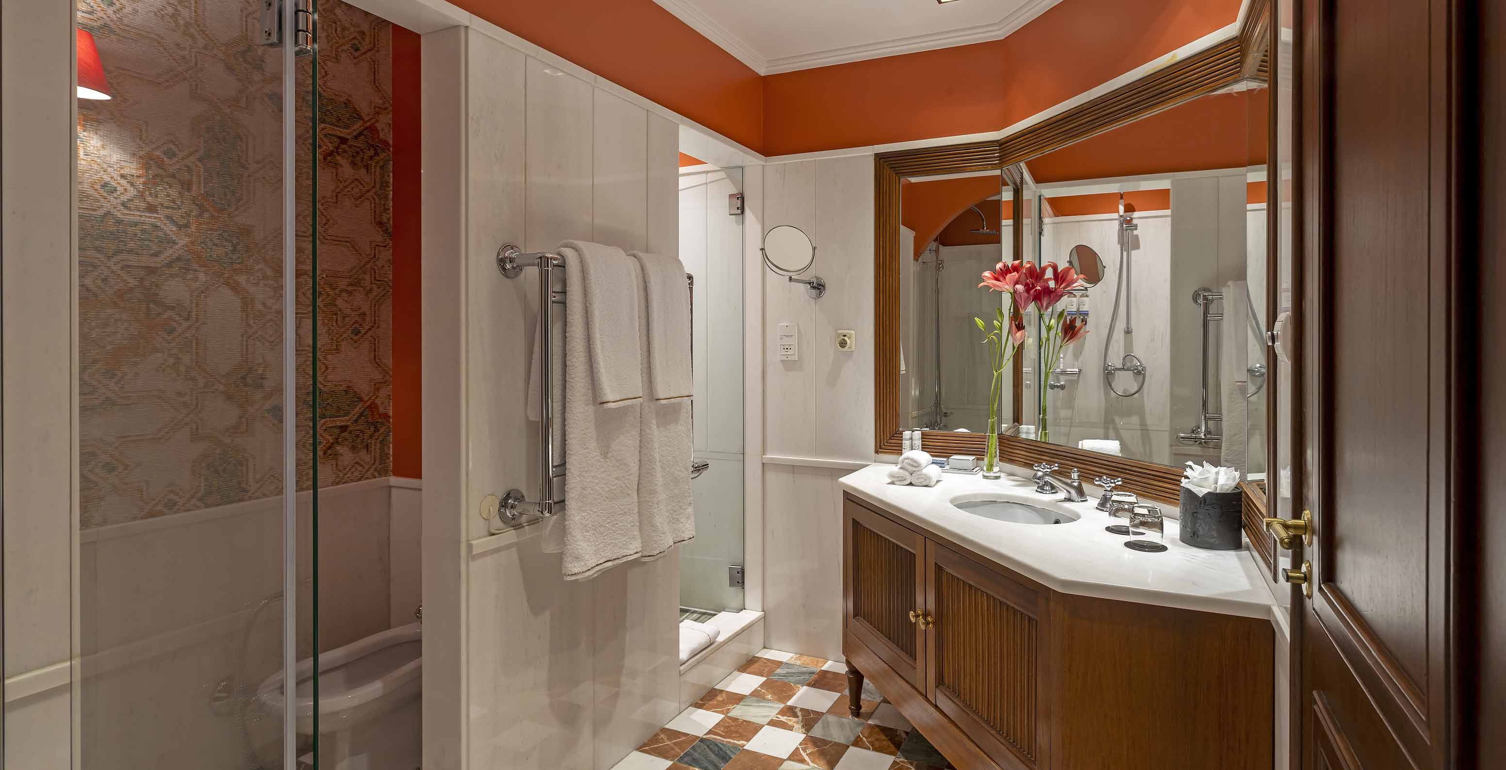 The Suite at Pestana Palace Lisboa has a bathroom with a shower, bathtub, toilet, bidet, and a large sink with a mirror