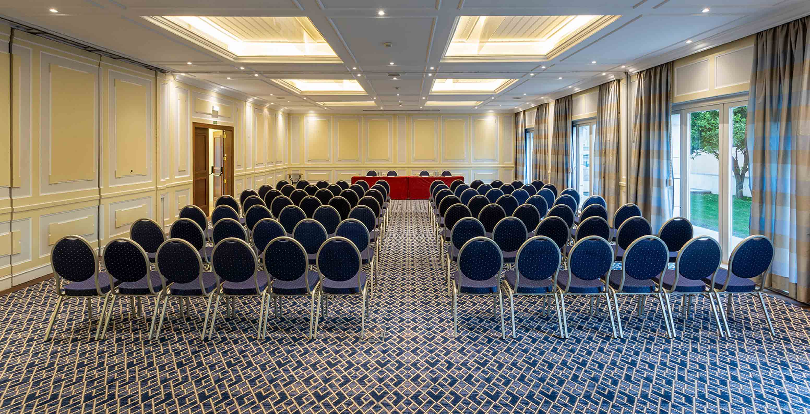 Pestana Palace Lisboa has a meeting room with blue carpet, large windows and long grey curtains