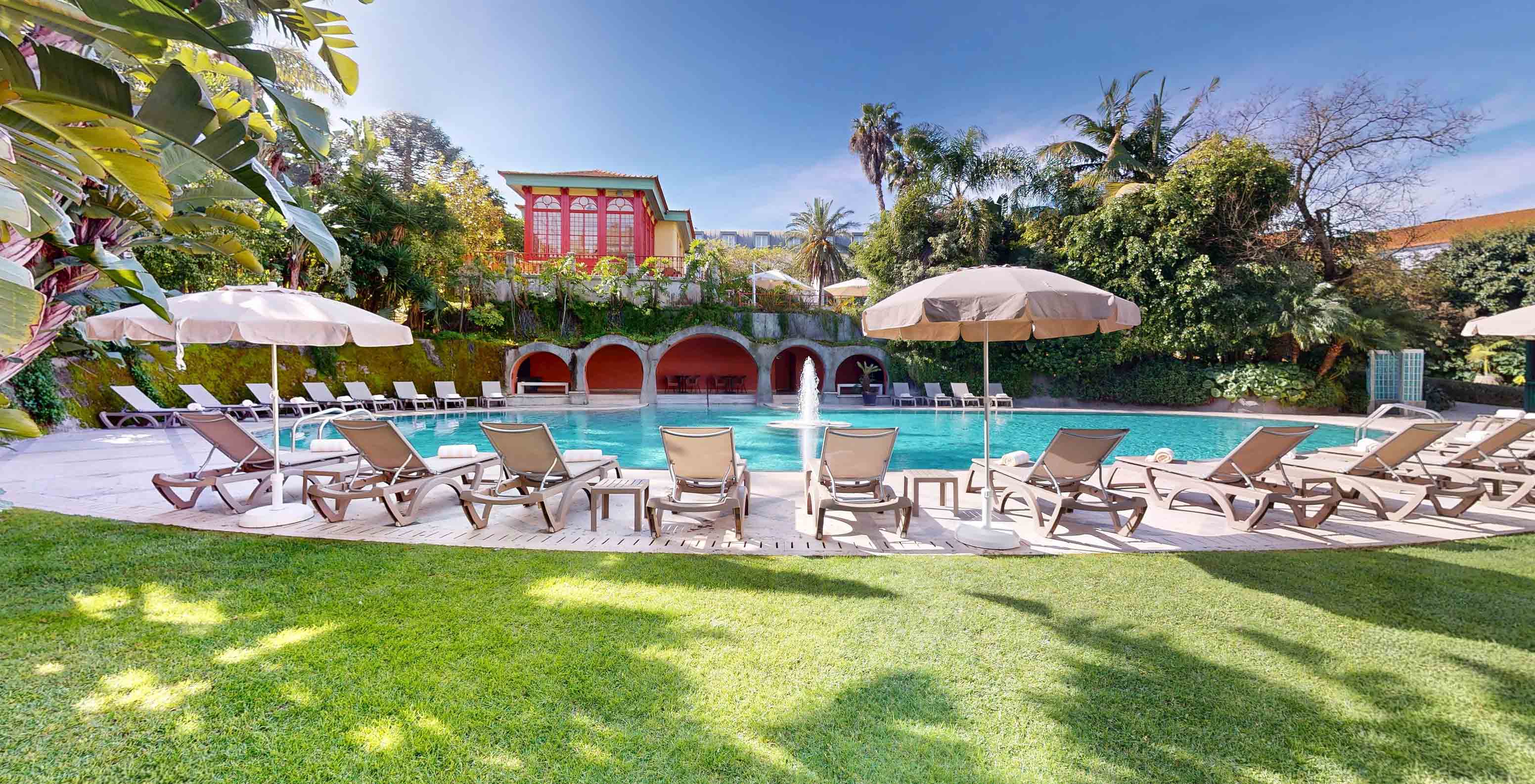 Outdoor pool with a central fountain and loungers at Palace Lisboa, a hotel in a palace with pools and spa