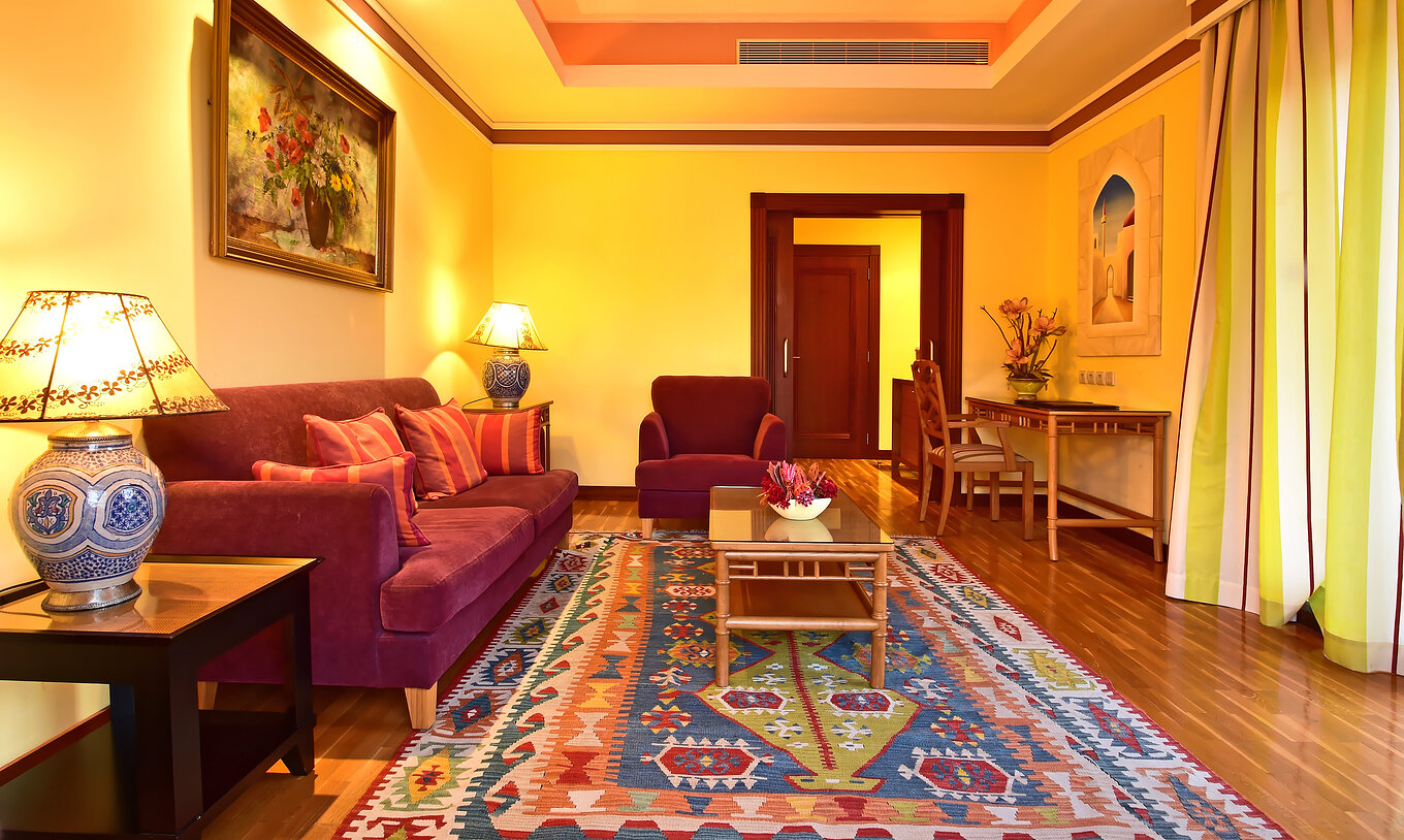 The Superior Suite of Pestana Sintra Golf has a room with sofa, an armchair, and a desk with a chair