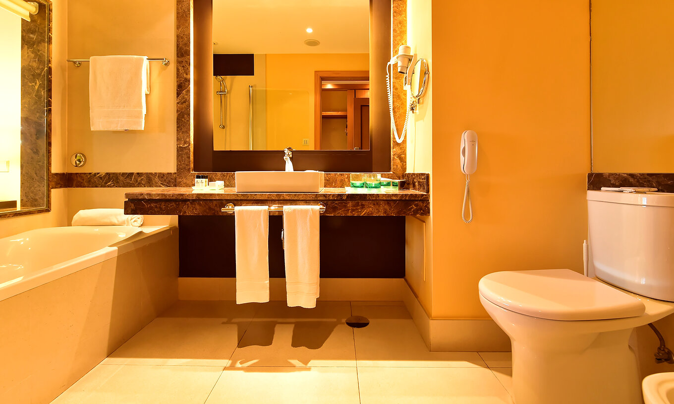 The Classic Pool View of Pestana Promenade has a bathroom with bathtub, sink, and a square mirror