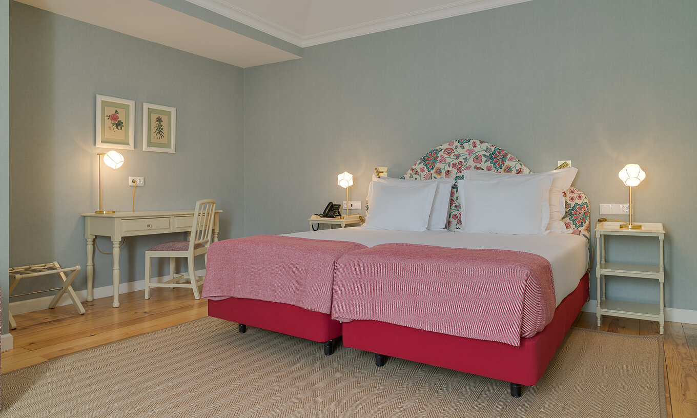Junior Suite at Pestana Quinta Perestrello has two single beds, bedside table, and a desk