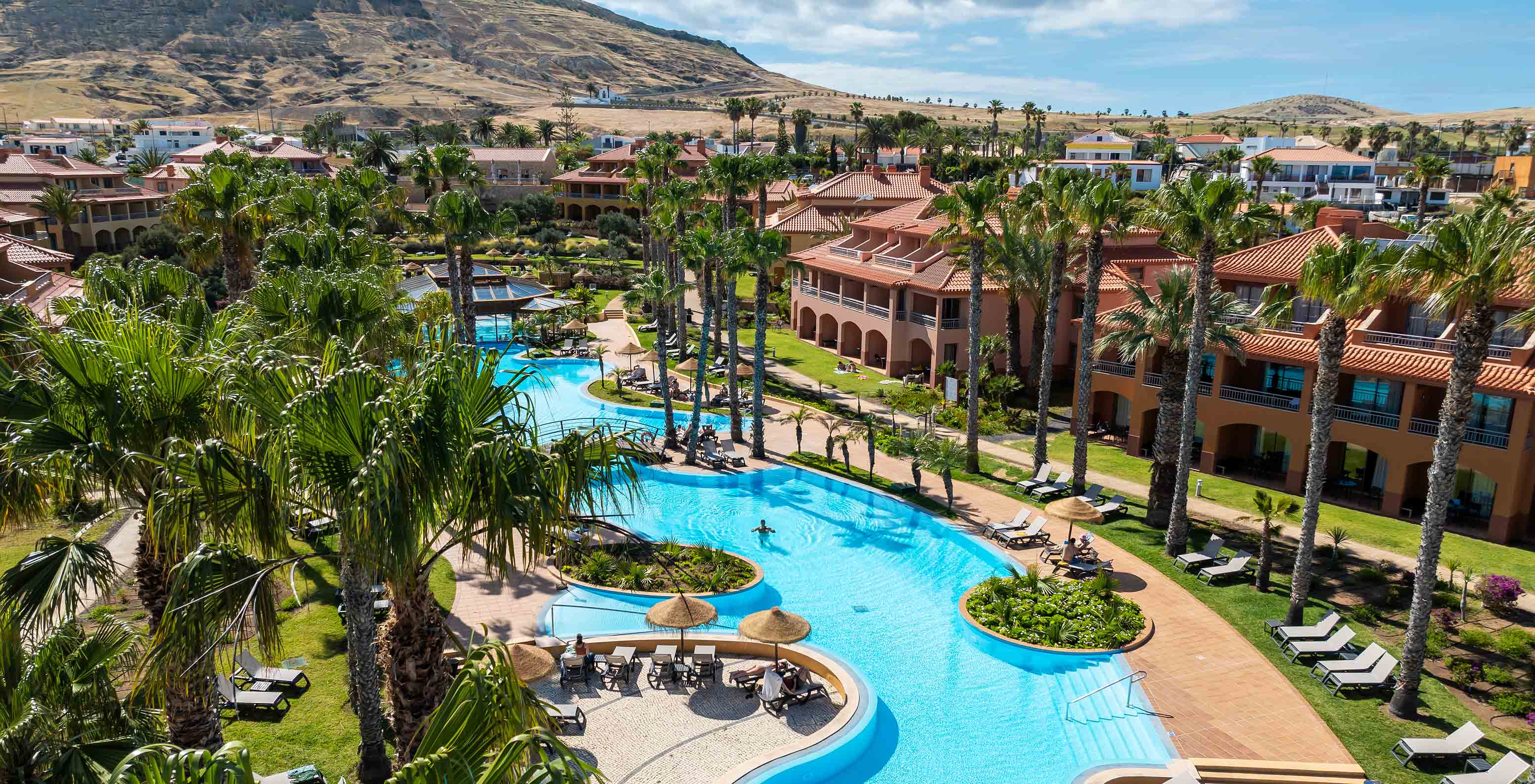 Layout of the villas at Pestana Porto Santo All Inclusive, surrounded by vegetation and with the outdoor pool in the center