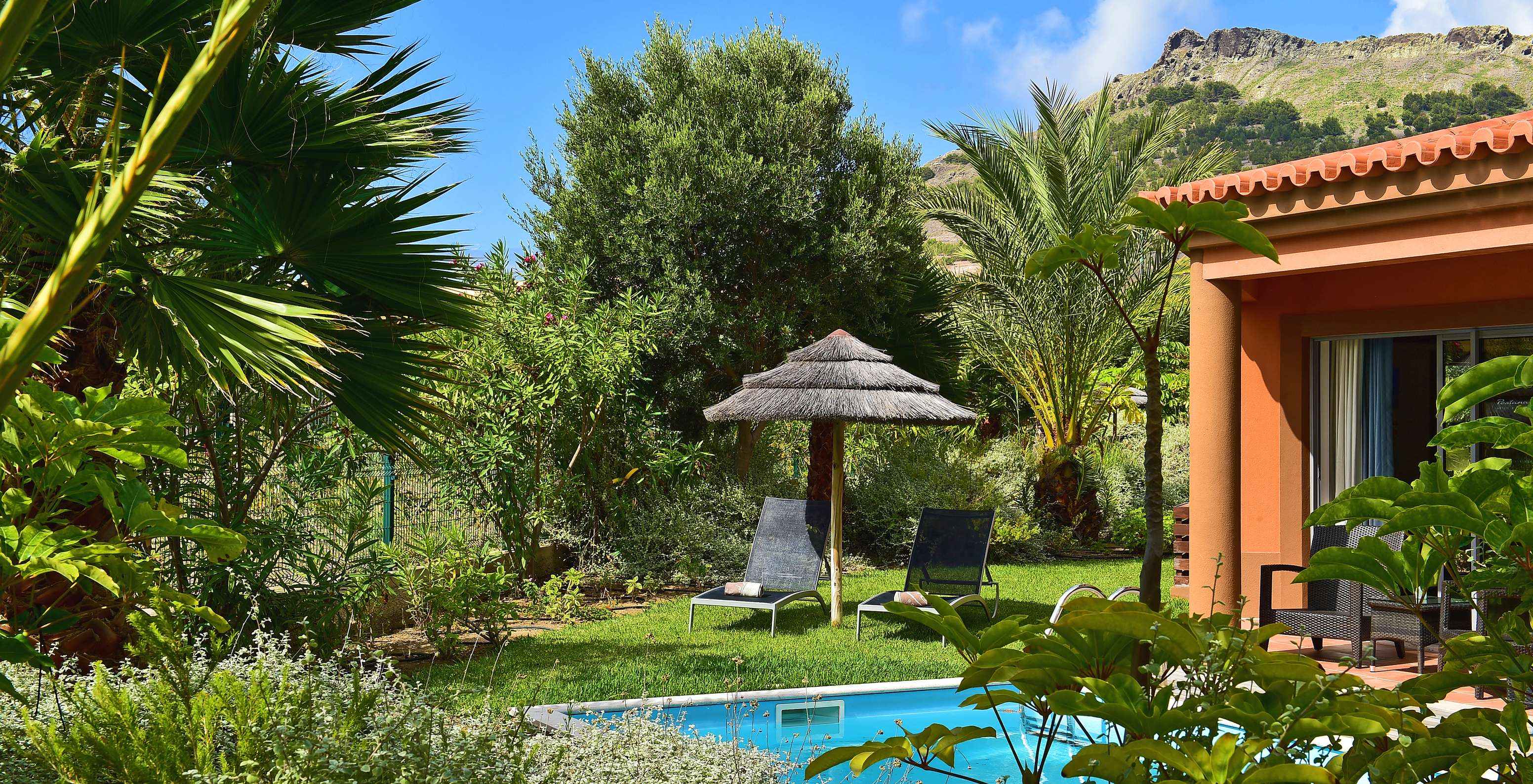 The Pool Villa of Pestana Porto Santo All Inclusive has a private pool, loungers, and a straw hat